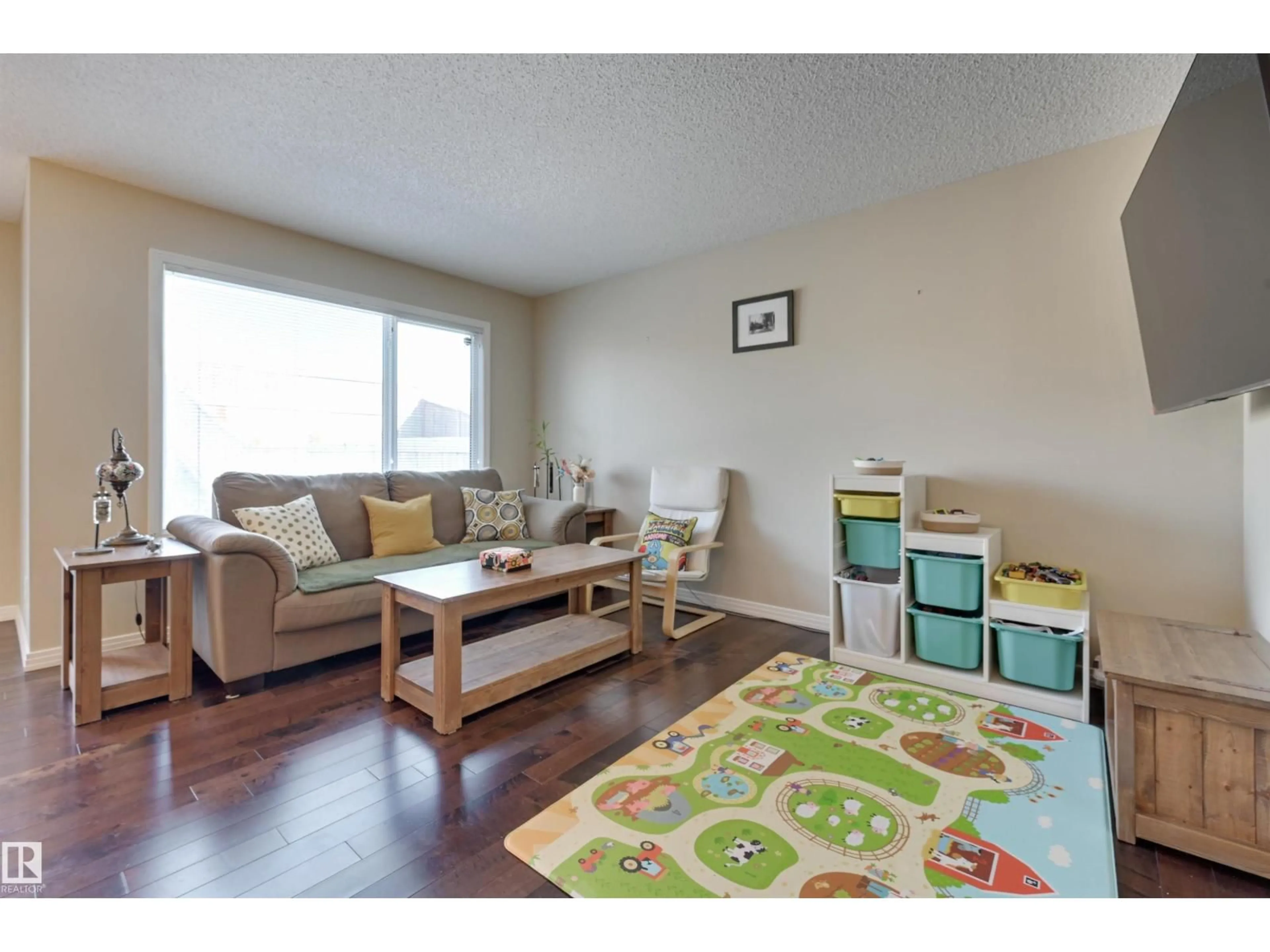 Living room with furniture, wood/laminate floor for 1426 152 AV, Edmonton Alberta T5Y0Y7