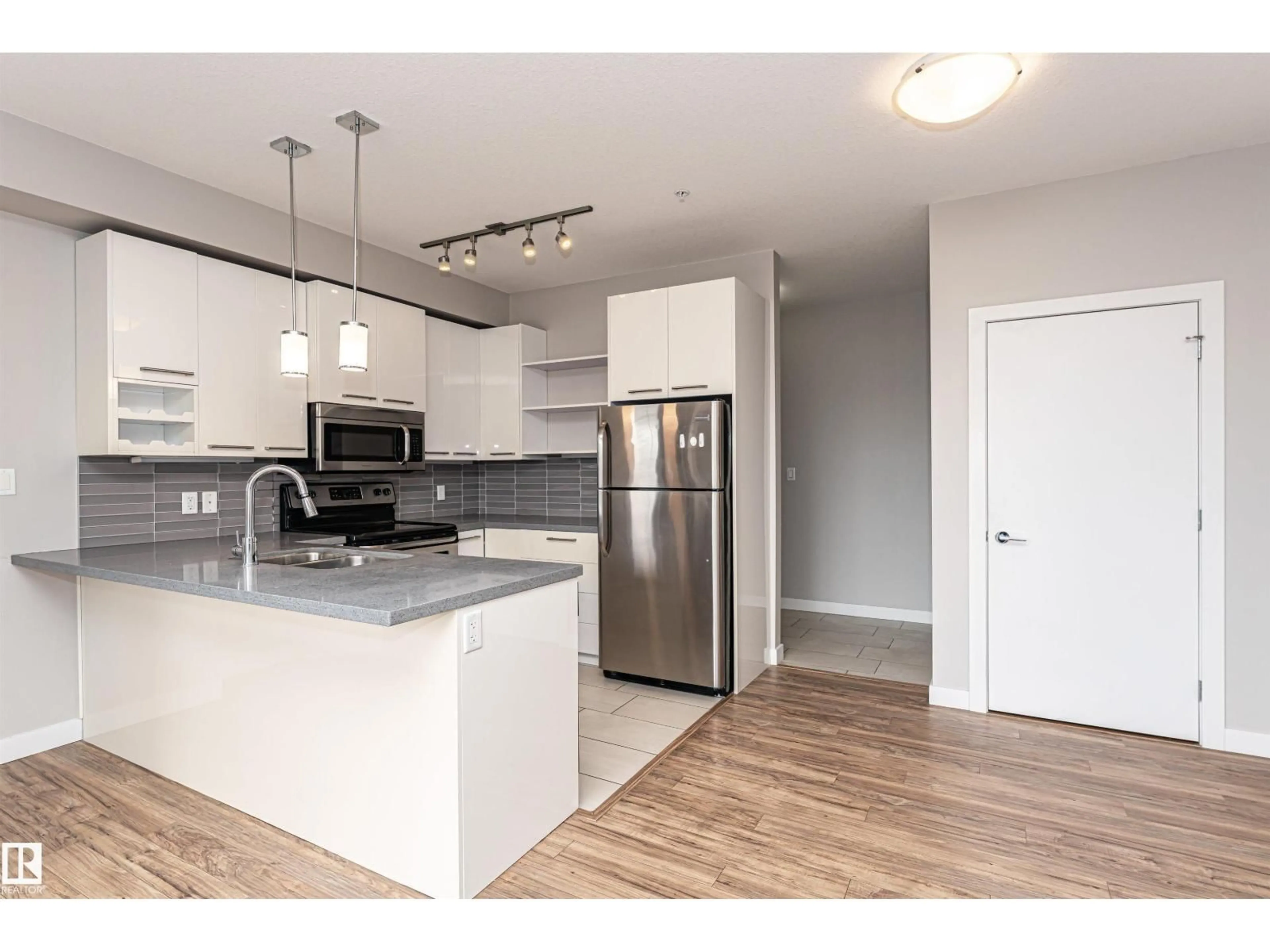 Open concept kitchen, wood/laminate floor for #313 - 10418 81 AV, Edmonton Alberta T6E1X5