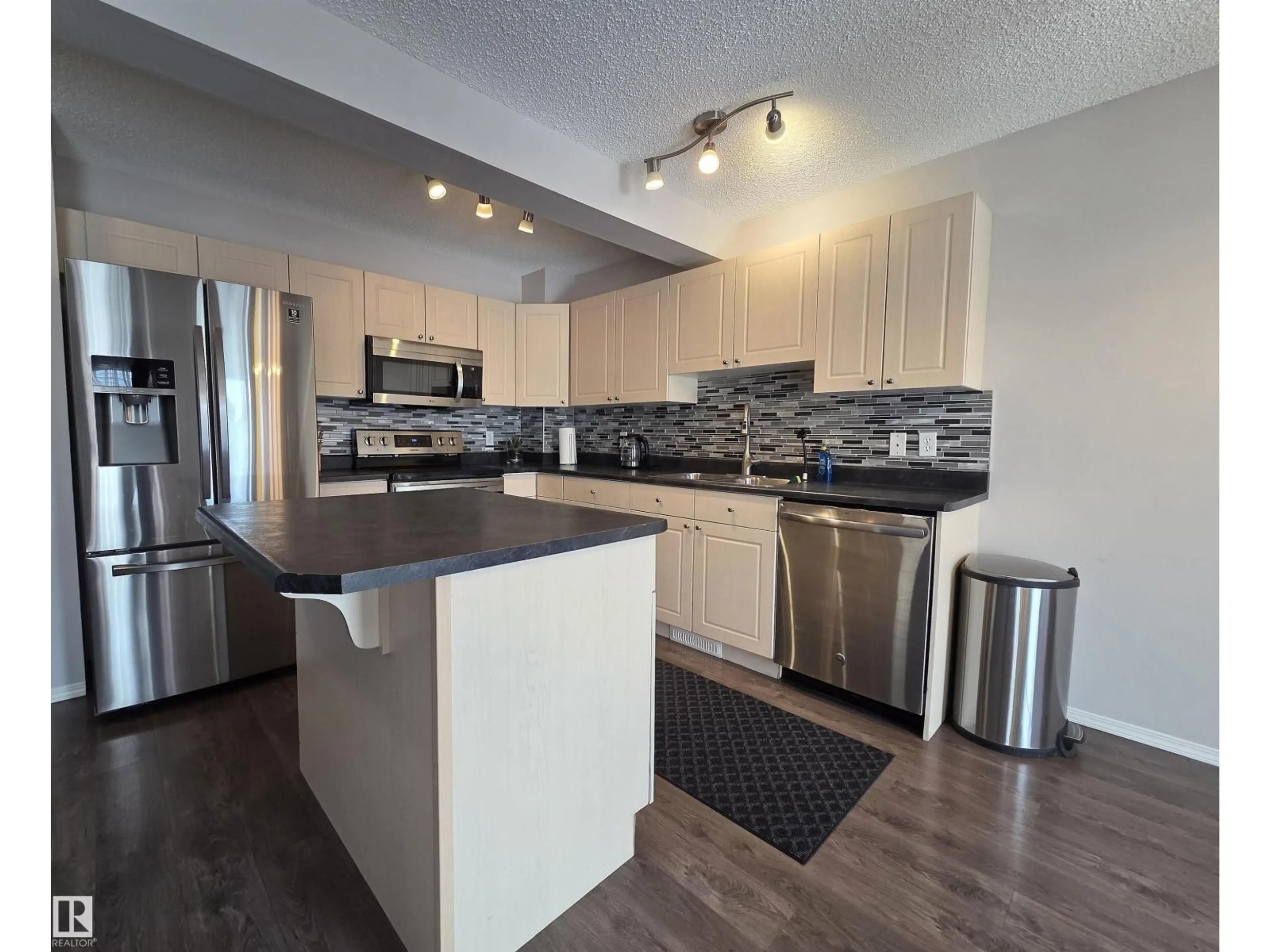 Open concept kitchen, wood/laminate floor for NW - 5424 204 ST, Edmonton Alberta T6M2Z1