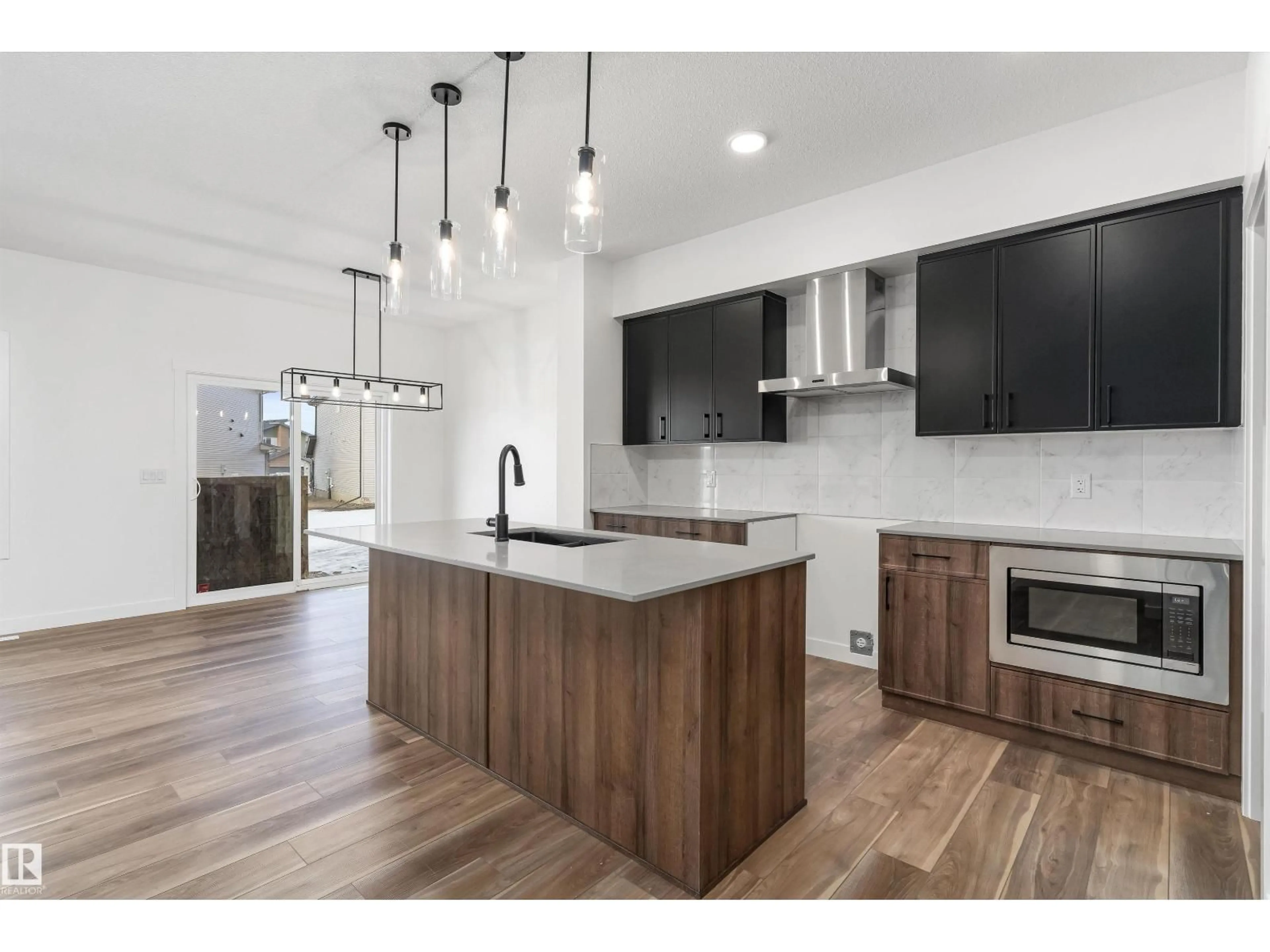 Open concept kitchen, wood/laminate floor for NW - 4023 207 ST, Edmonton Alberta T6M3G1