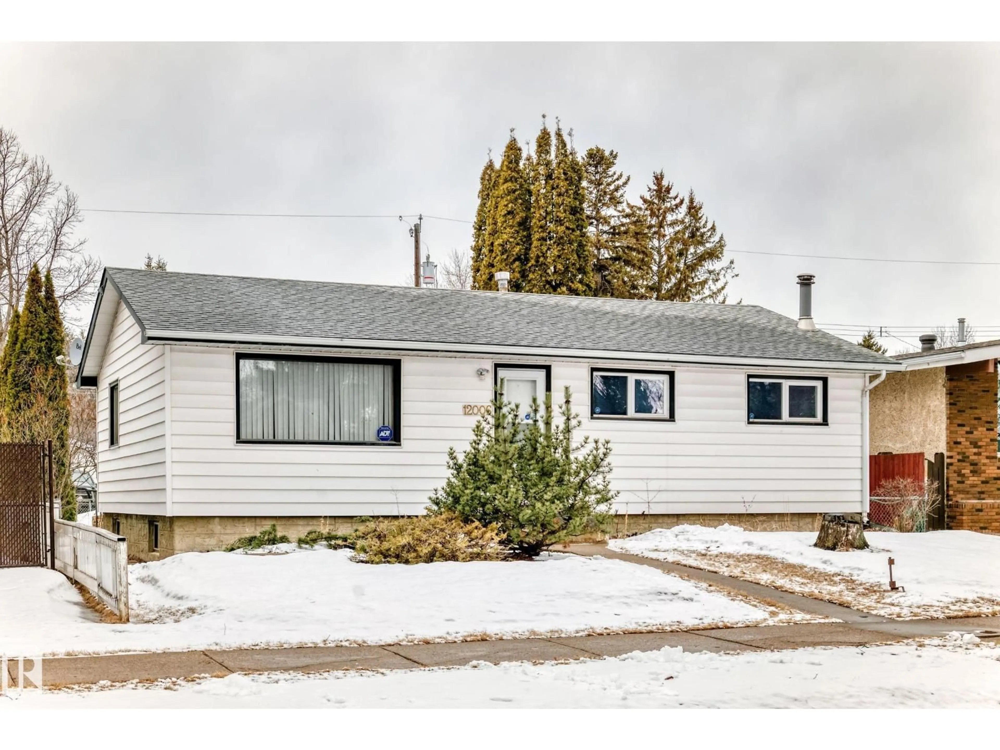 Home with vinyl exterior material, street for 12006 41 ST, Edmonton Alberta T5W2M4