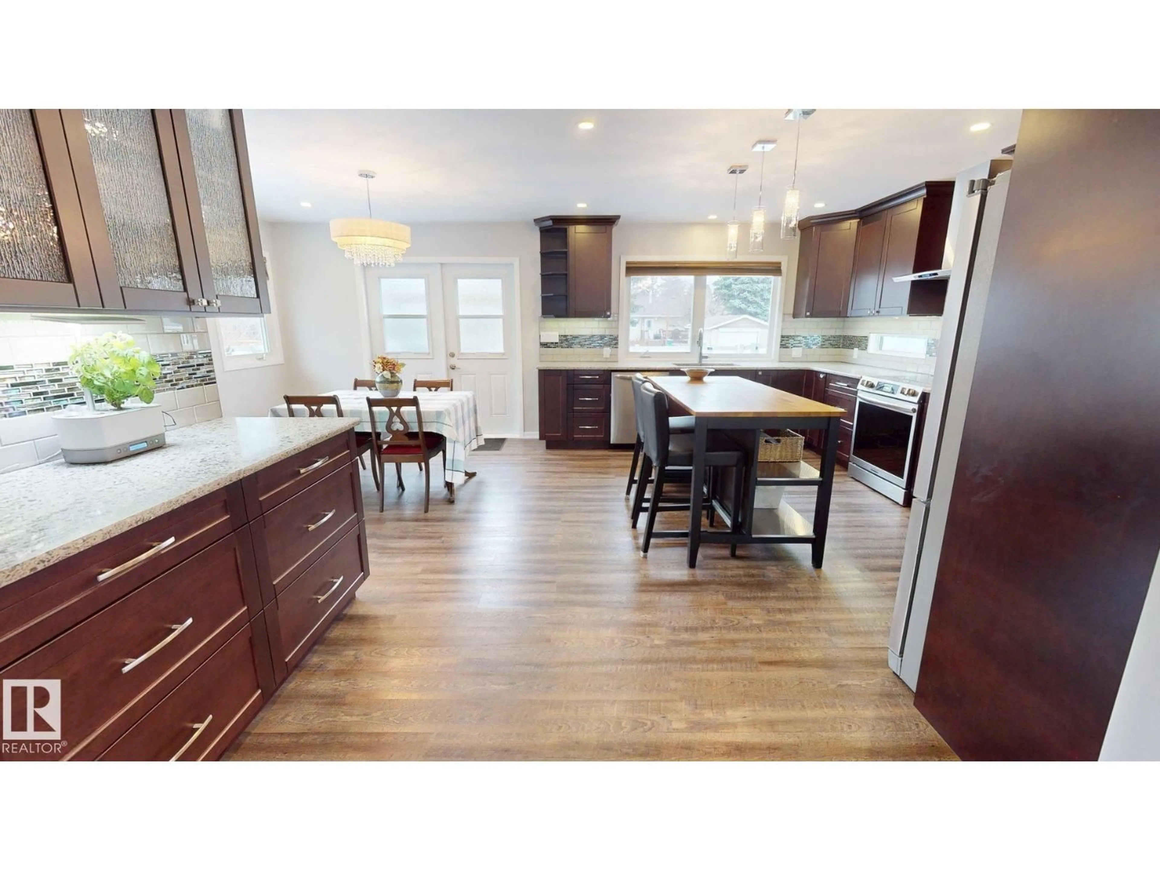 Open concept kitchen, wood/laminate floor for 10655 52 ST, Edmonton Alberta T6A2H1