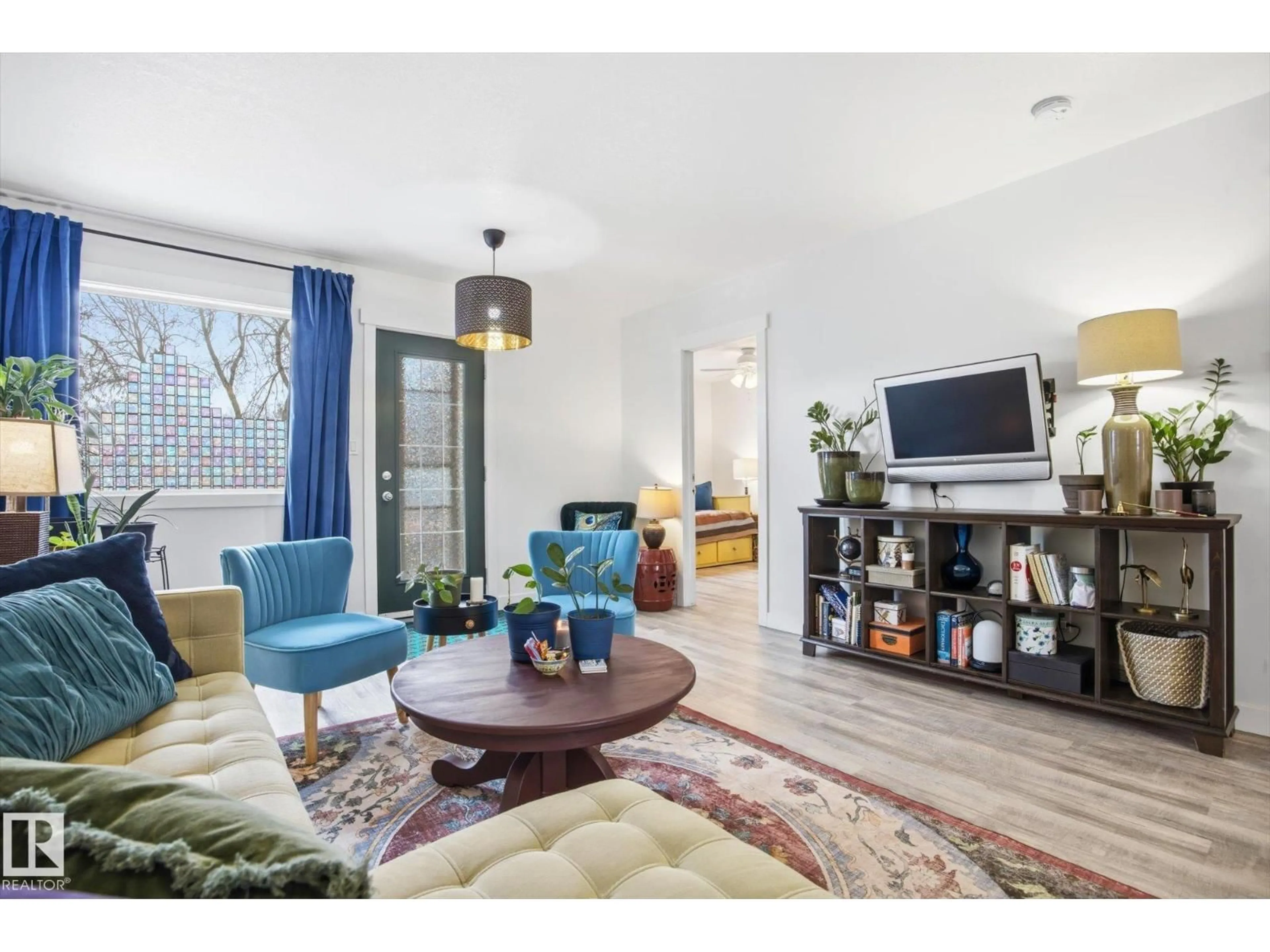 Living room with furniture, wood/laminate floor for 11728 86 ST, Edmonton Alberta T5B3J8