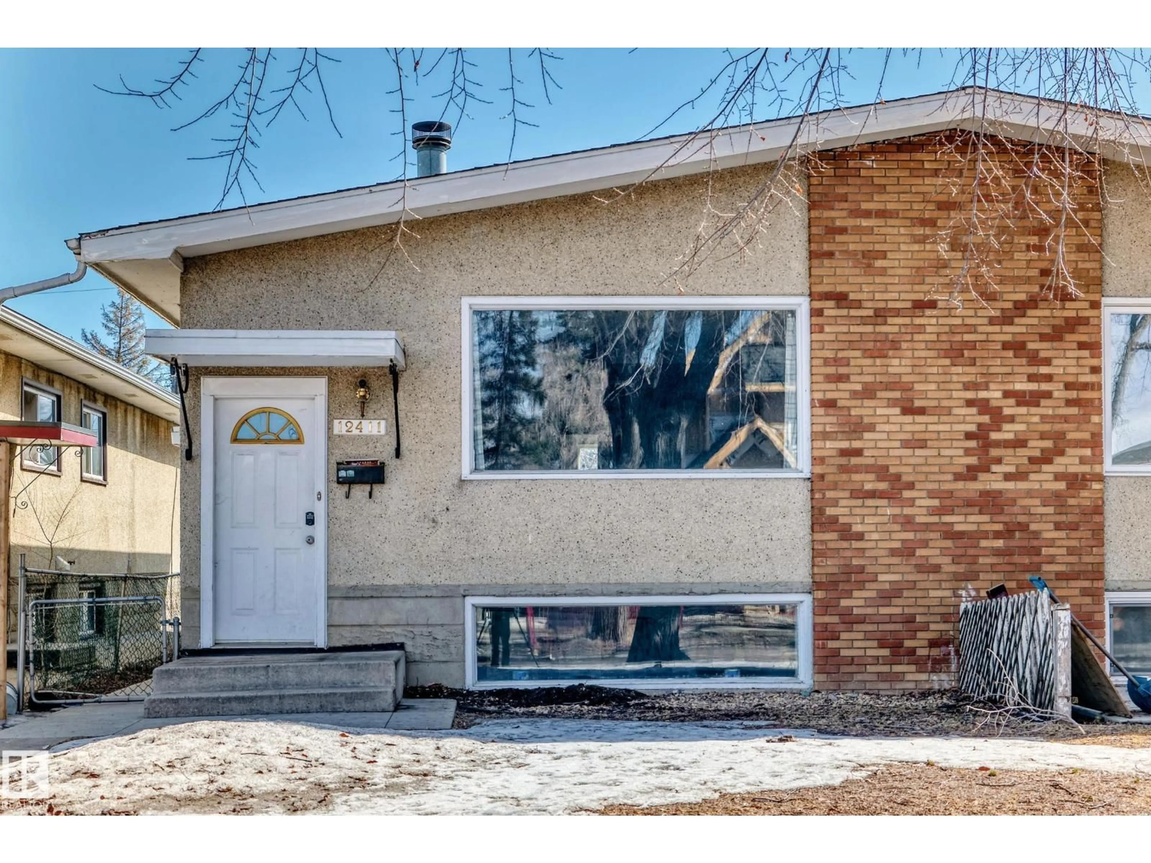 Home with vinyl exterior material, street for 12411 126 ST NW, Edmonton Alberta T5L0X2
