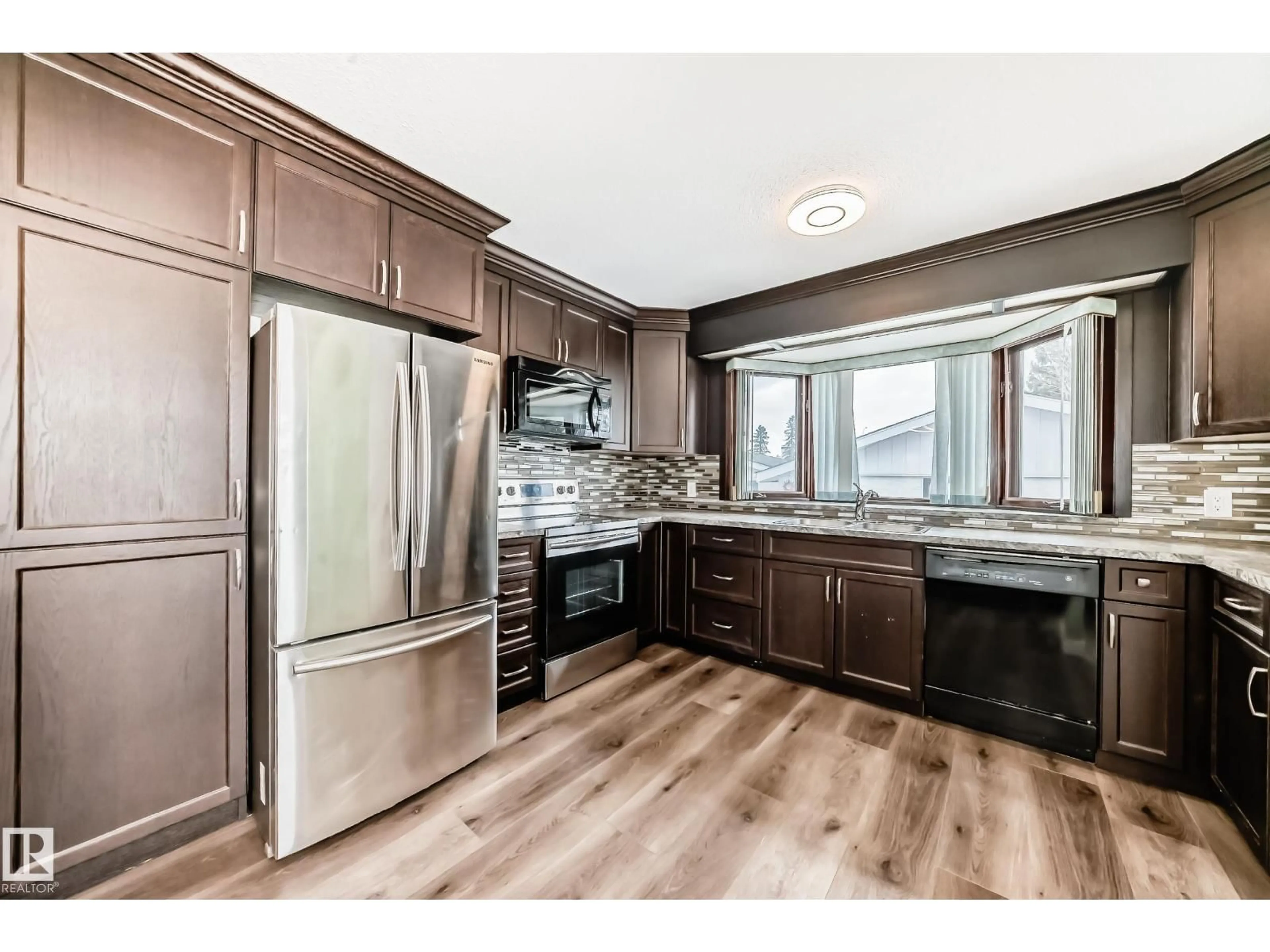 Open concept kitchen, wood/laminate floor for 17104 85 AV, Edmonton Alberta T5T0K8