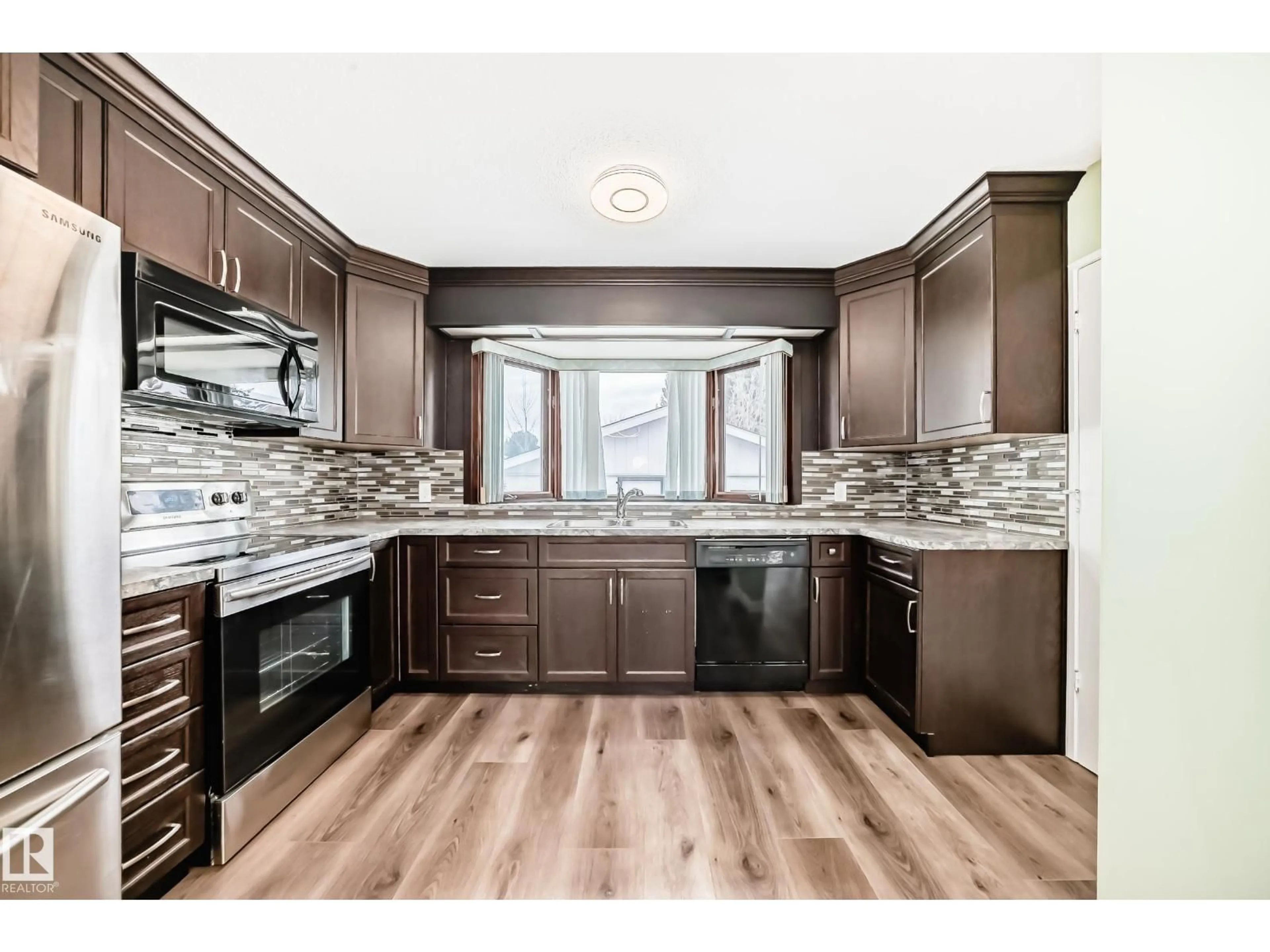 Open concept kitchen, wood/laminate floor for 17104 85 AV, Edmonton Alberta T5T0K8