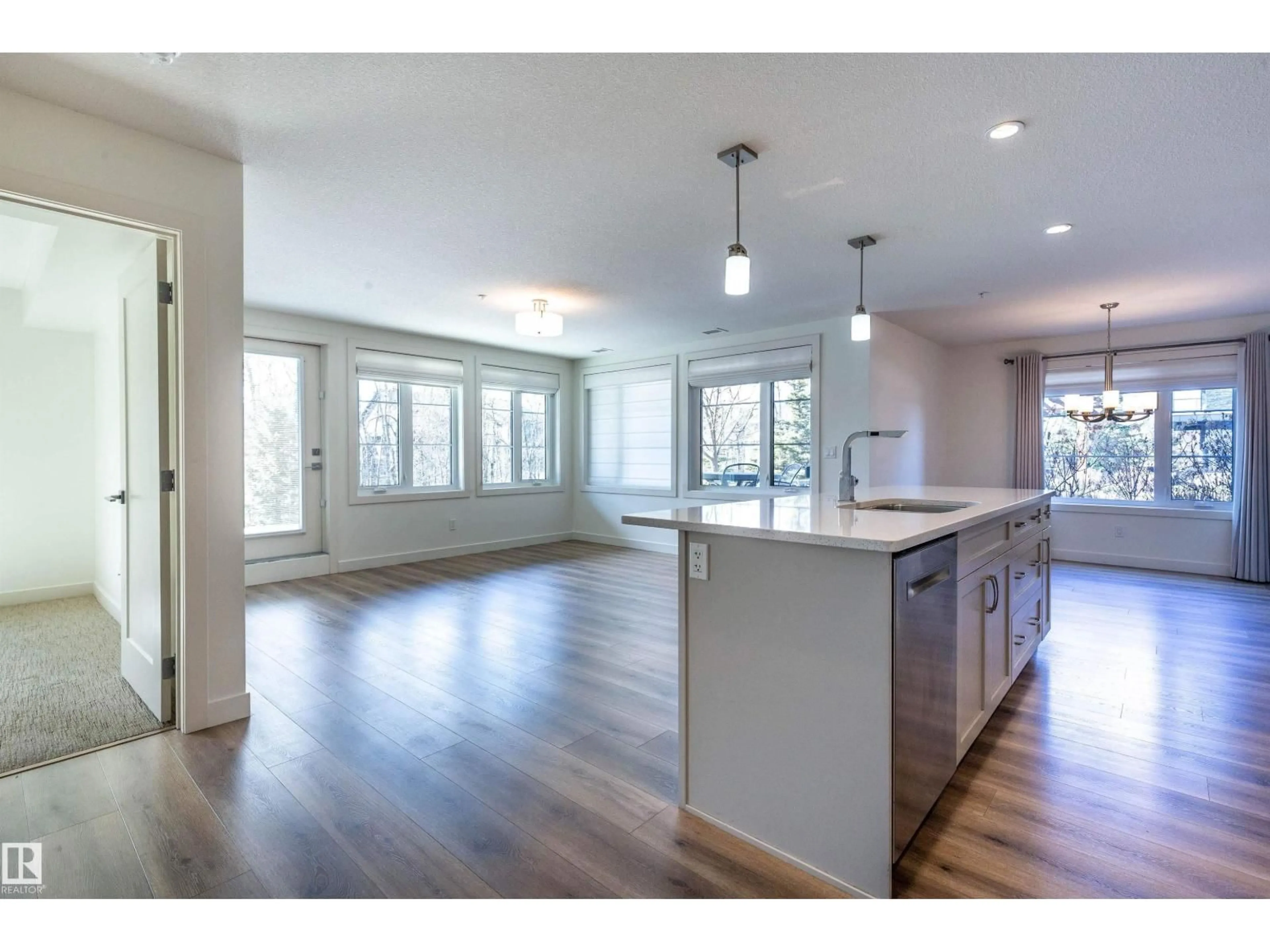 Open concept kitchen, wood/laminate floor for #108 - 5025 EDGEMONT BV, Edmonton Alberta T6M0S8