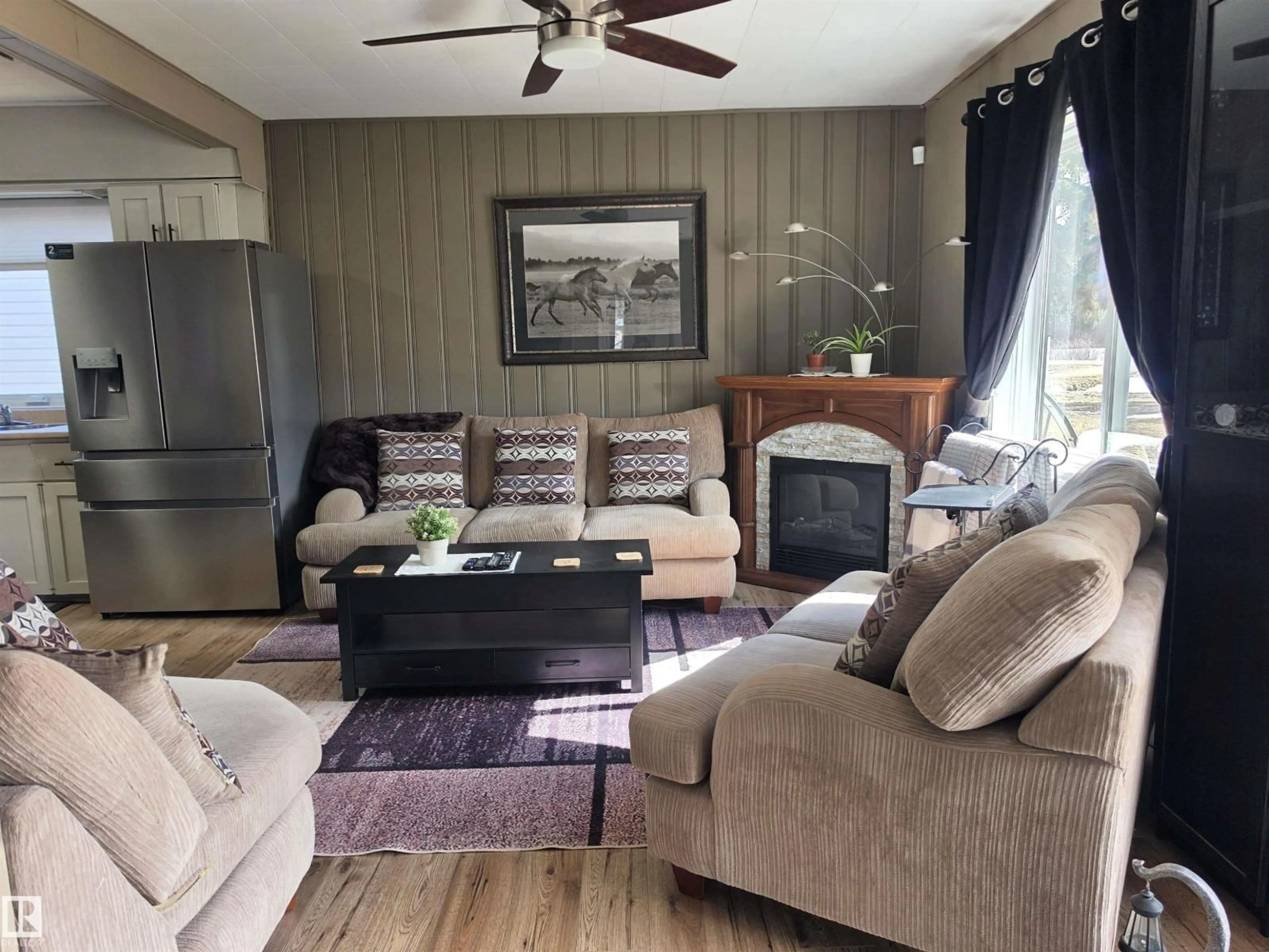 Living room with furniture, wood/laminate floor for 202 - 56102 RGE ROAD 53, Cherhill Alberta T0E0J0