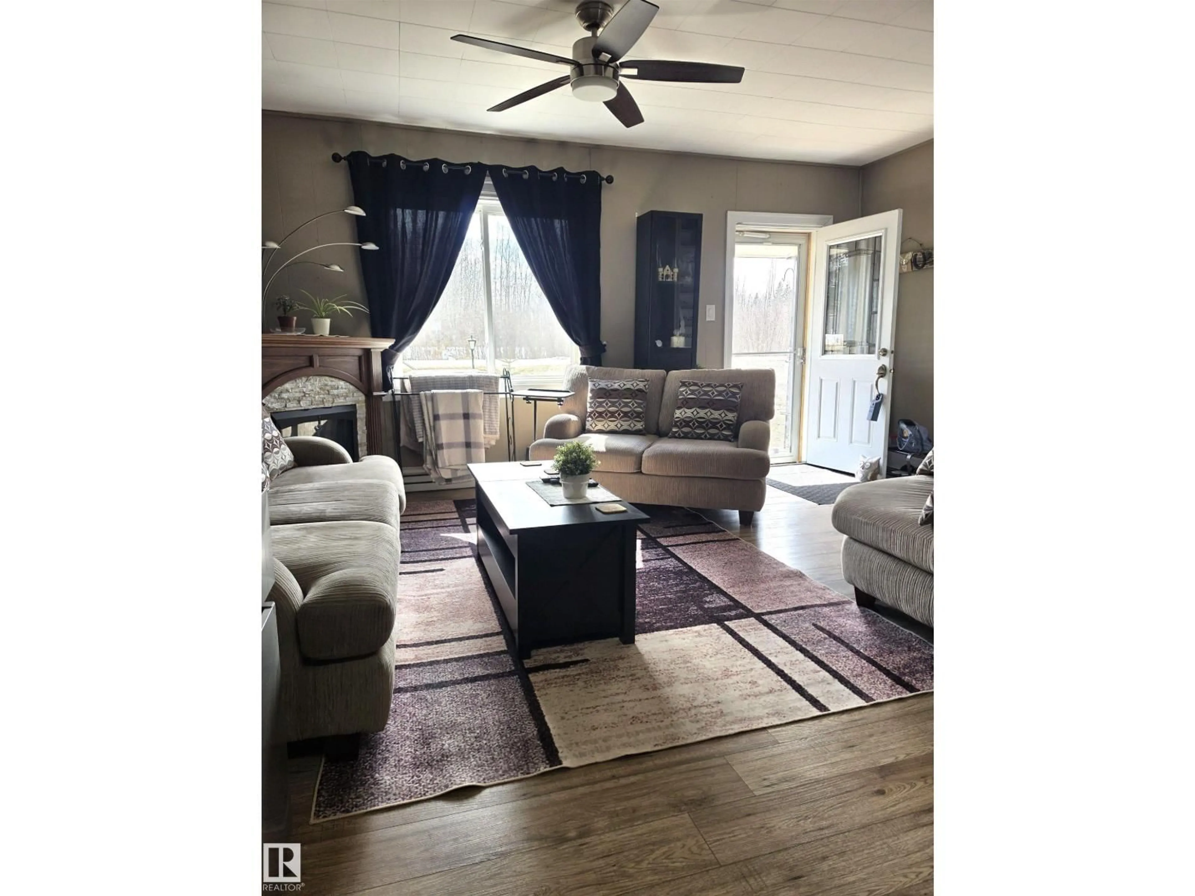 Living room with furniture, wood/laminate floor for 202 - 56102 RGE ROAD 53, Cherhill Alberta T0E0J0