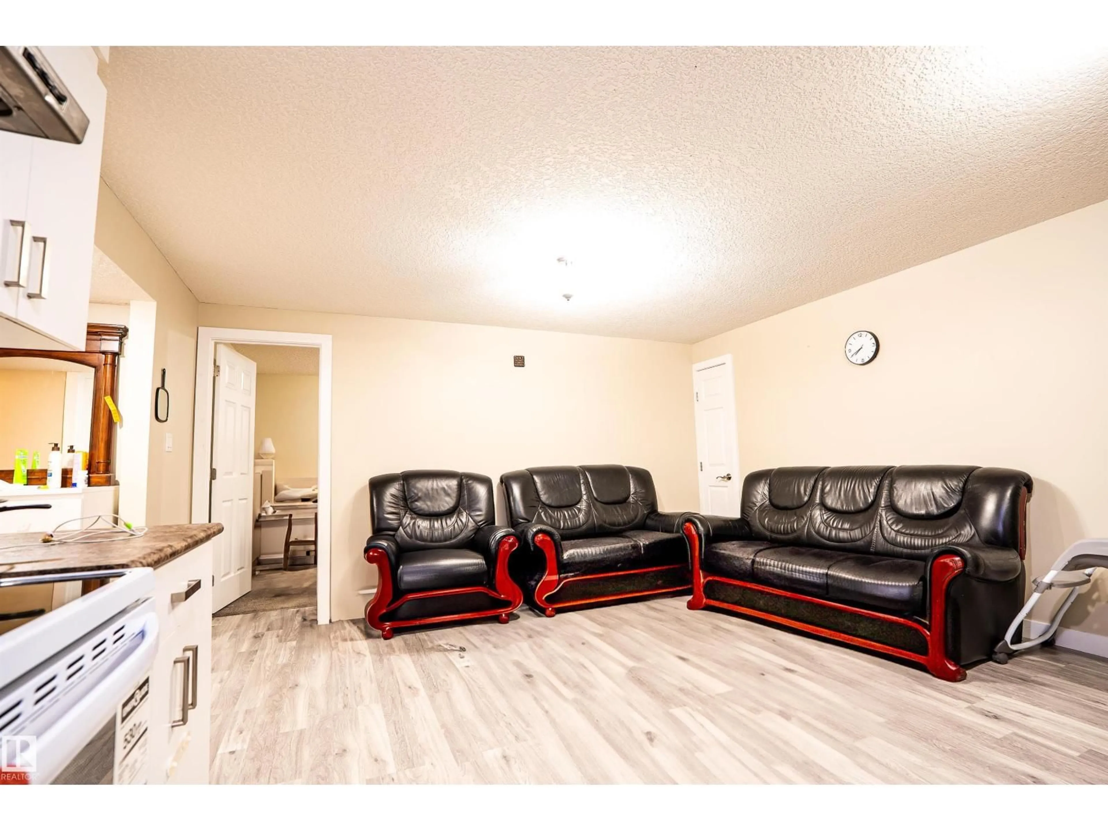 Living room with furniture, wood/laminate floor for NW - 1520 151 AV, Edmonton Alberta T5Y3T4