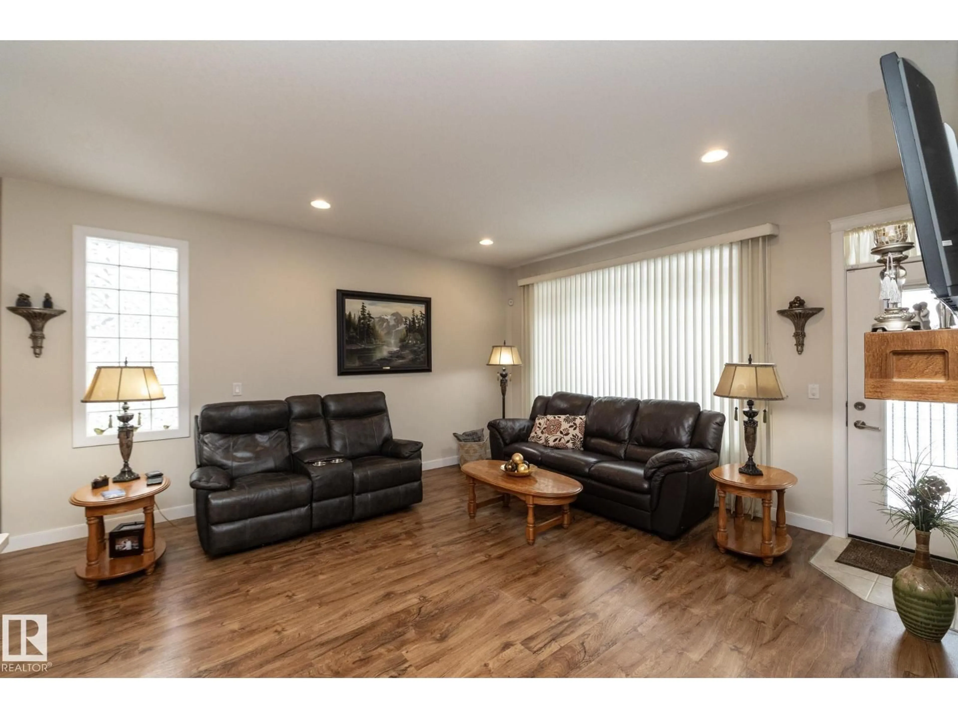 Living room with furniture, wood/laminate floor for 307 RAVINE CL, Devon Alberta T9G0A2