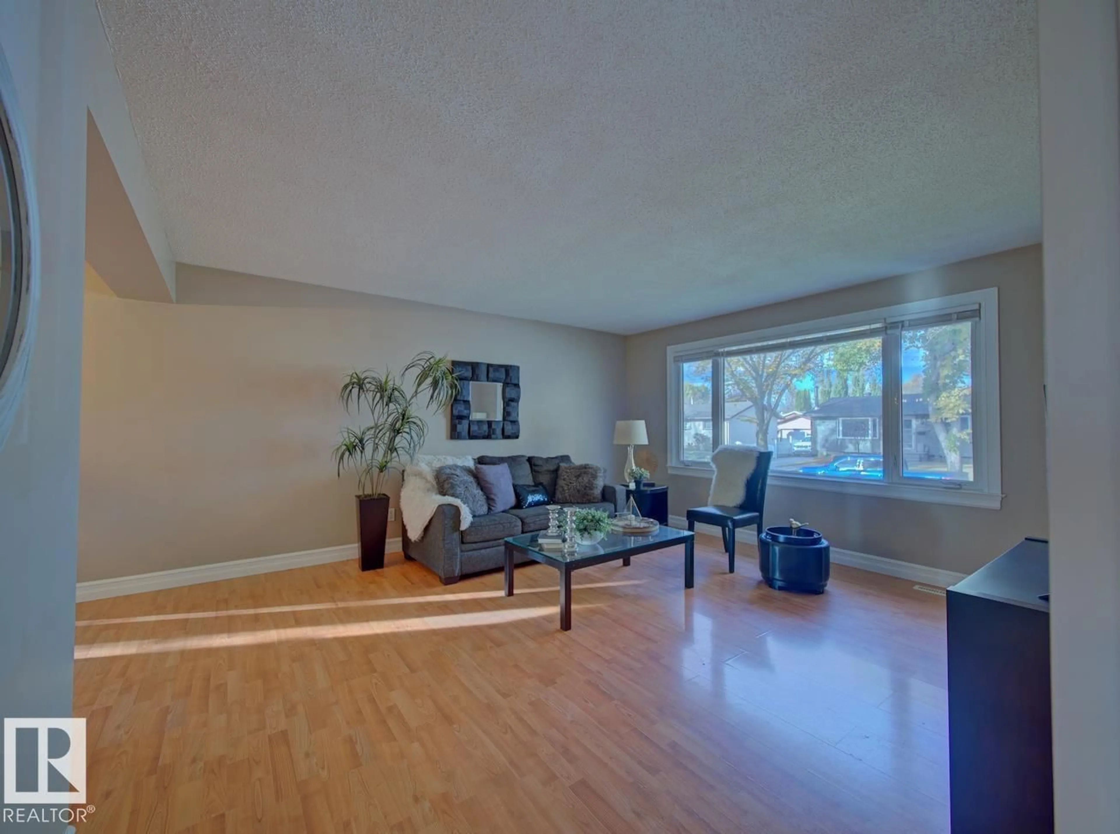 Living room with furniture, wood/laminate floor for 9621 89A ST, Fort Saskatchewan Alberta T8L1J5