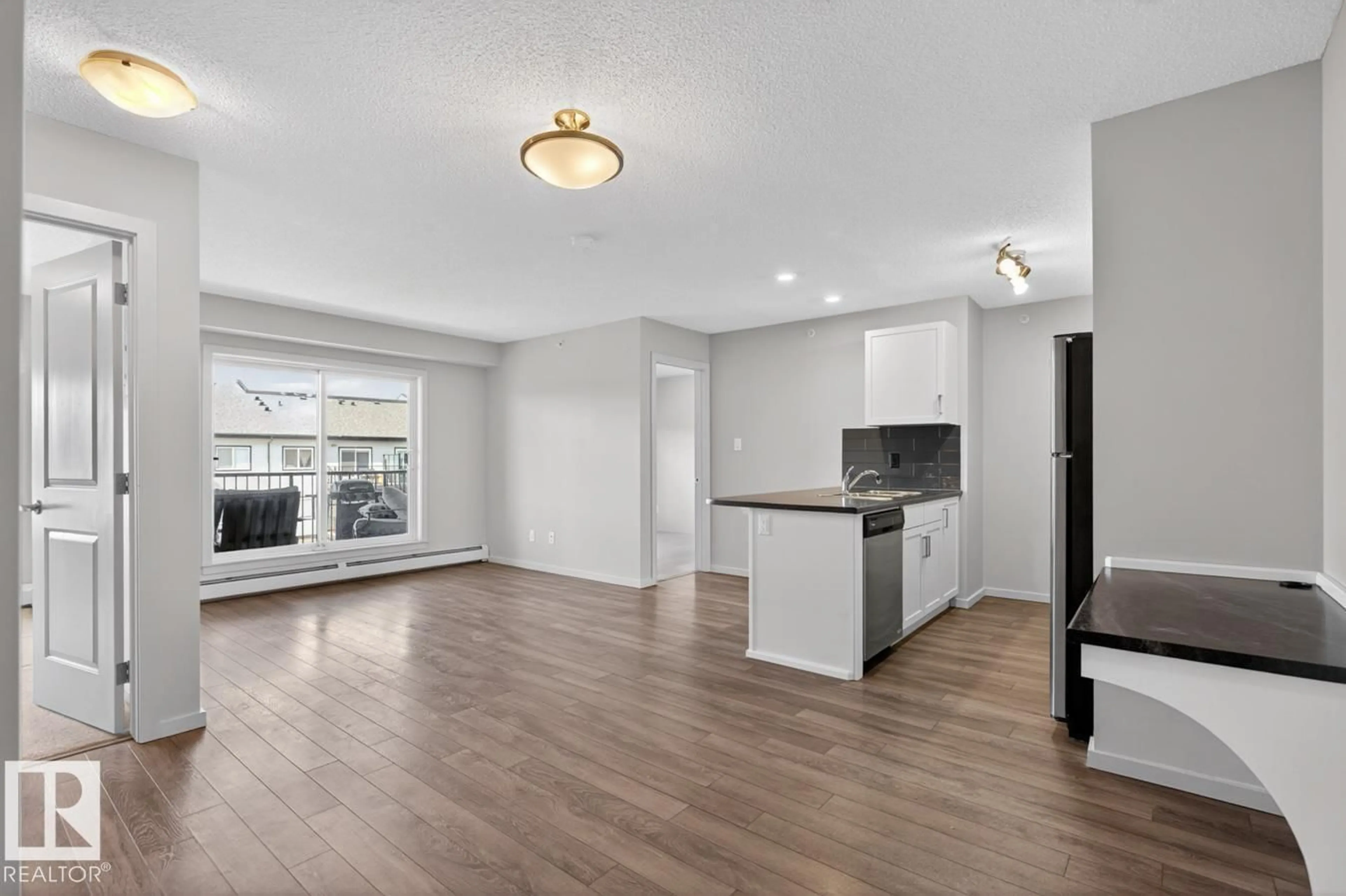Open concept kitchen, wood/laminate floor for 390 - 426 WINDERMERE RD, Edmonton Alberta T6W0R1