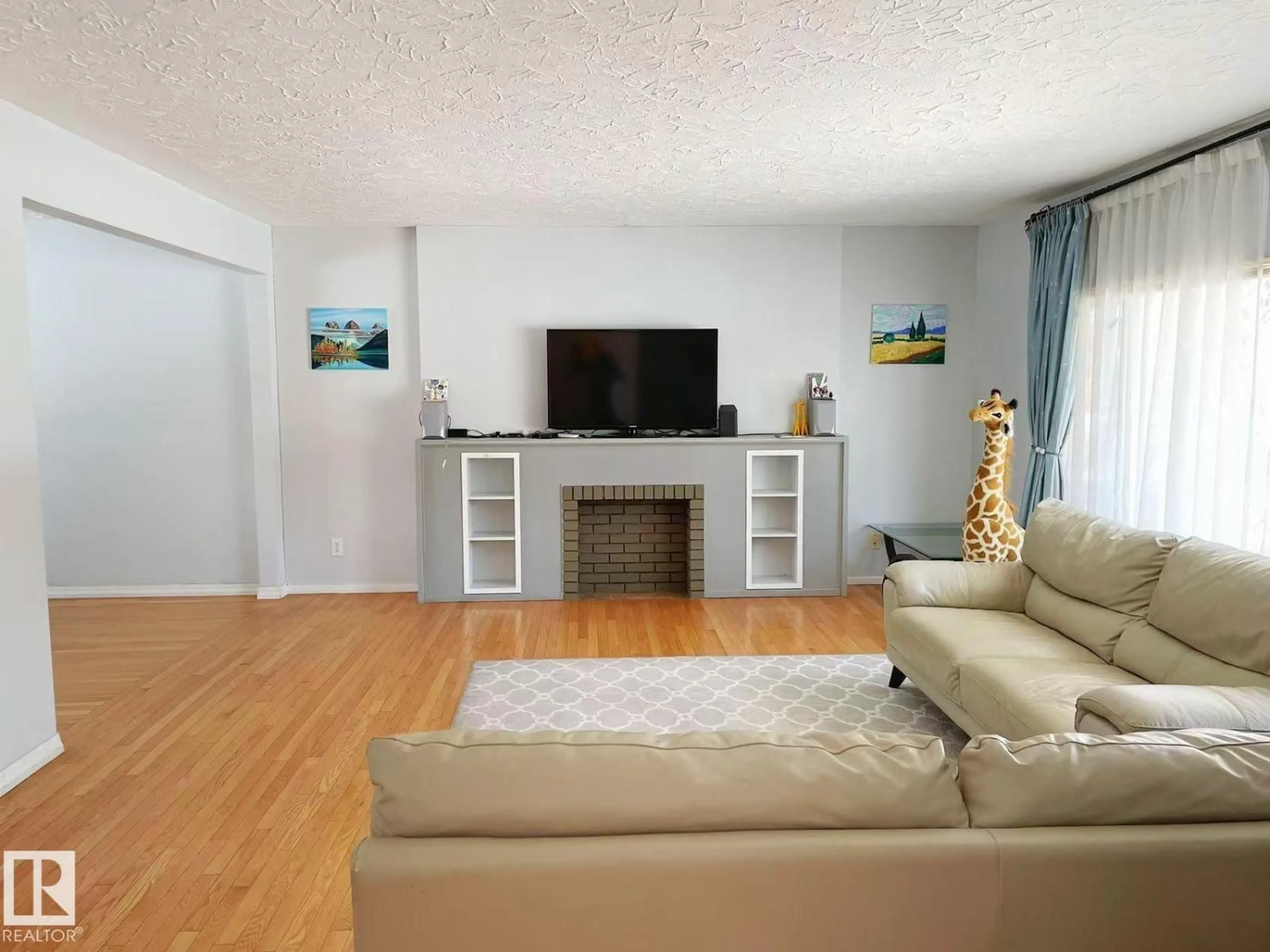 Living room with furniture, wood/laminate floor for 7634 119 ST, Edmonton Alberta T6G1W3