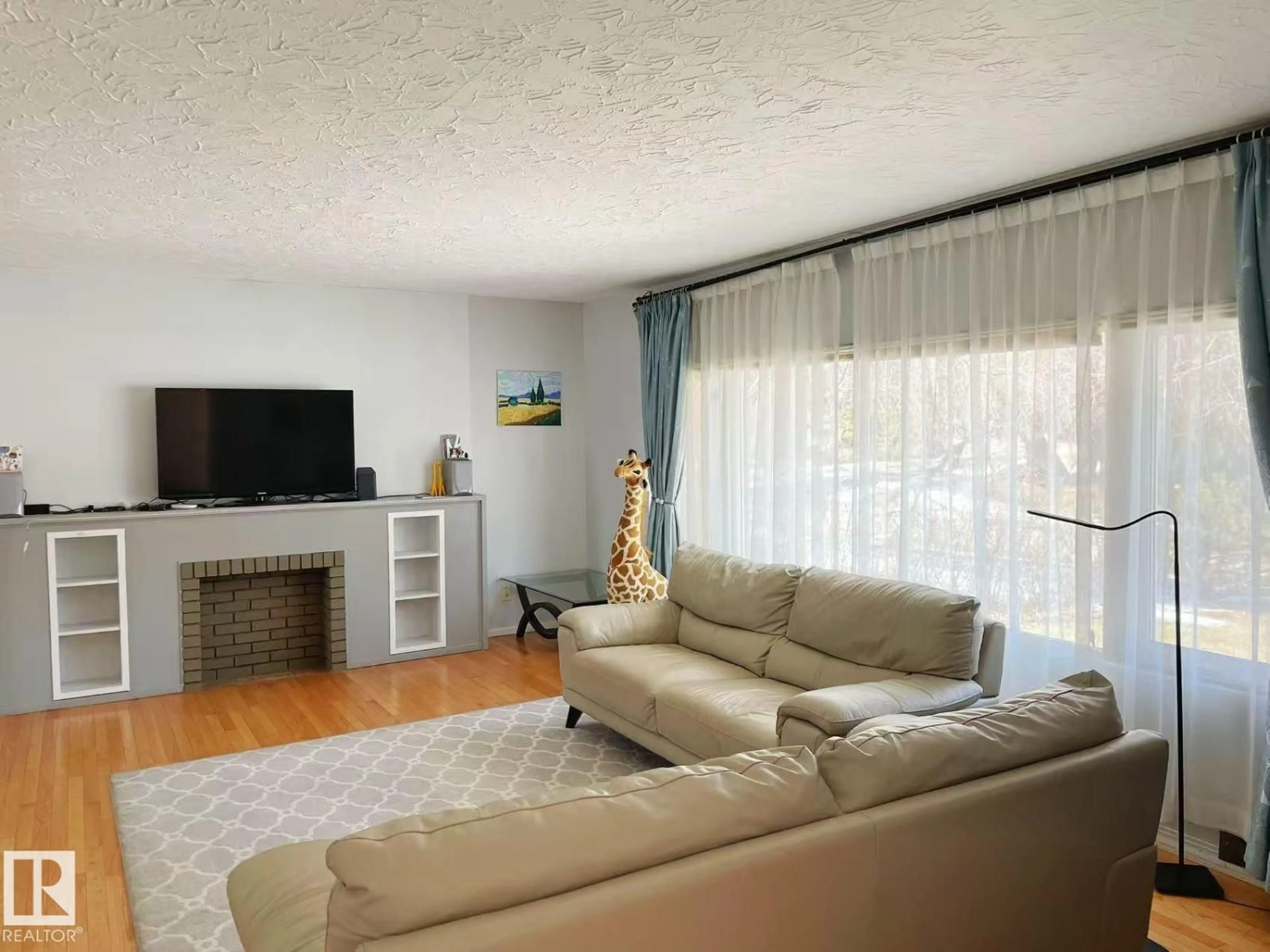 Living room with furniture, wood/laminate floor for 7634 119 ST, Edmonton Alberta T6G1W3