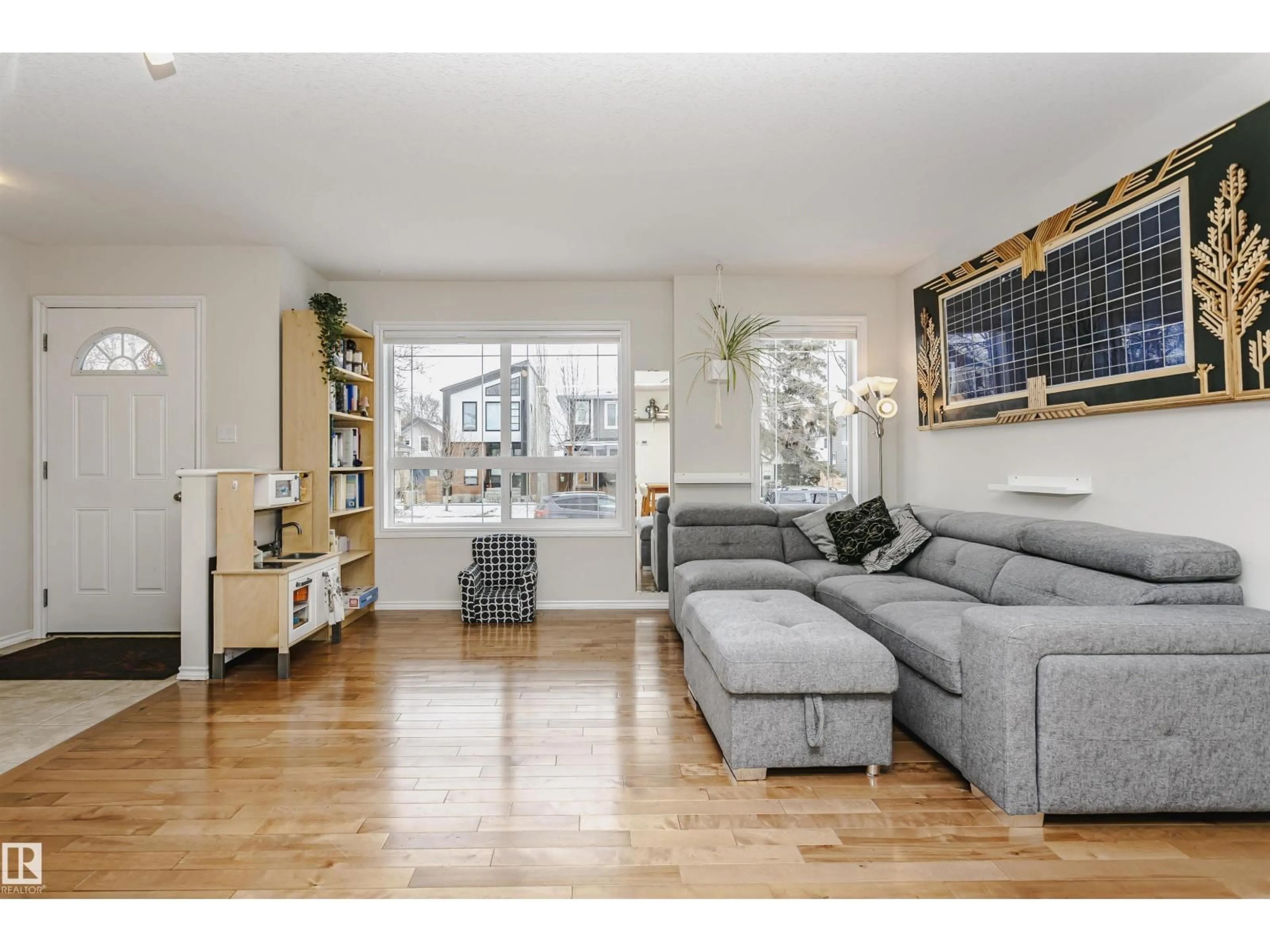 Living room with furniture, wood/laminate floor for 9359 74 AV, Edmonton Alberta T6E1E3