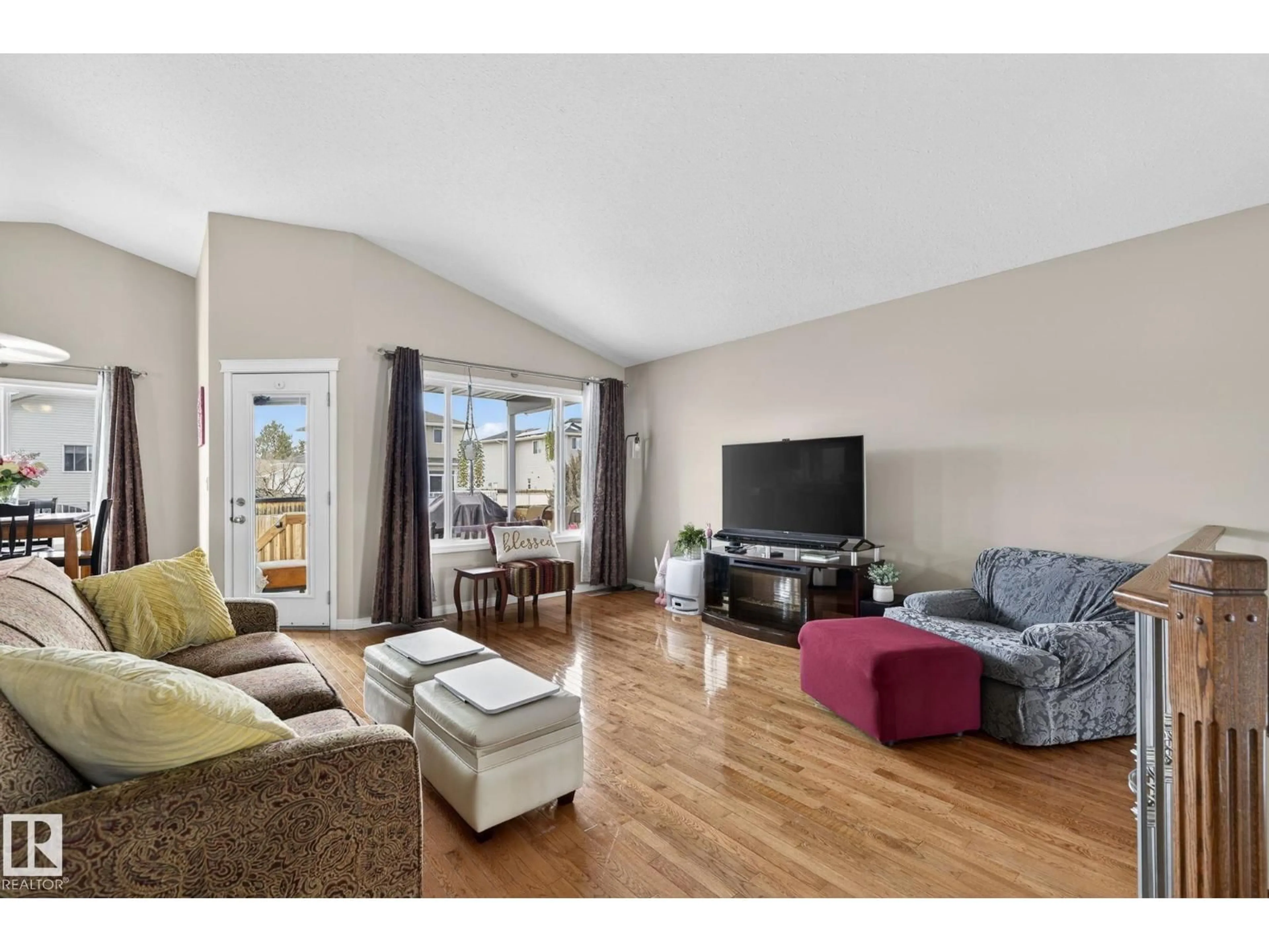 Living room with furniture, wood/laminate floor for 5414 59 ST, Camrose Alberta T4V5B9