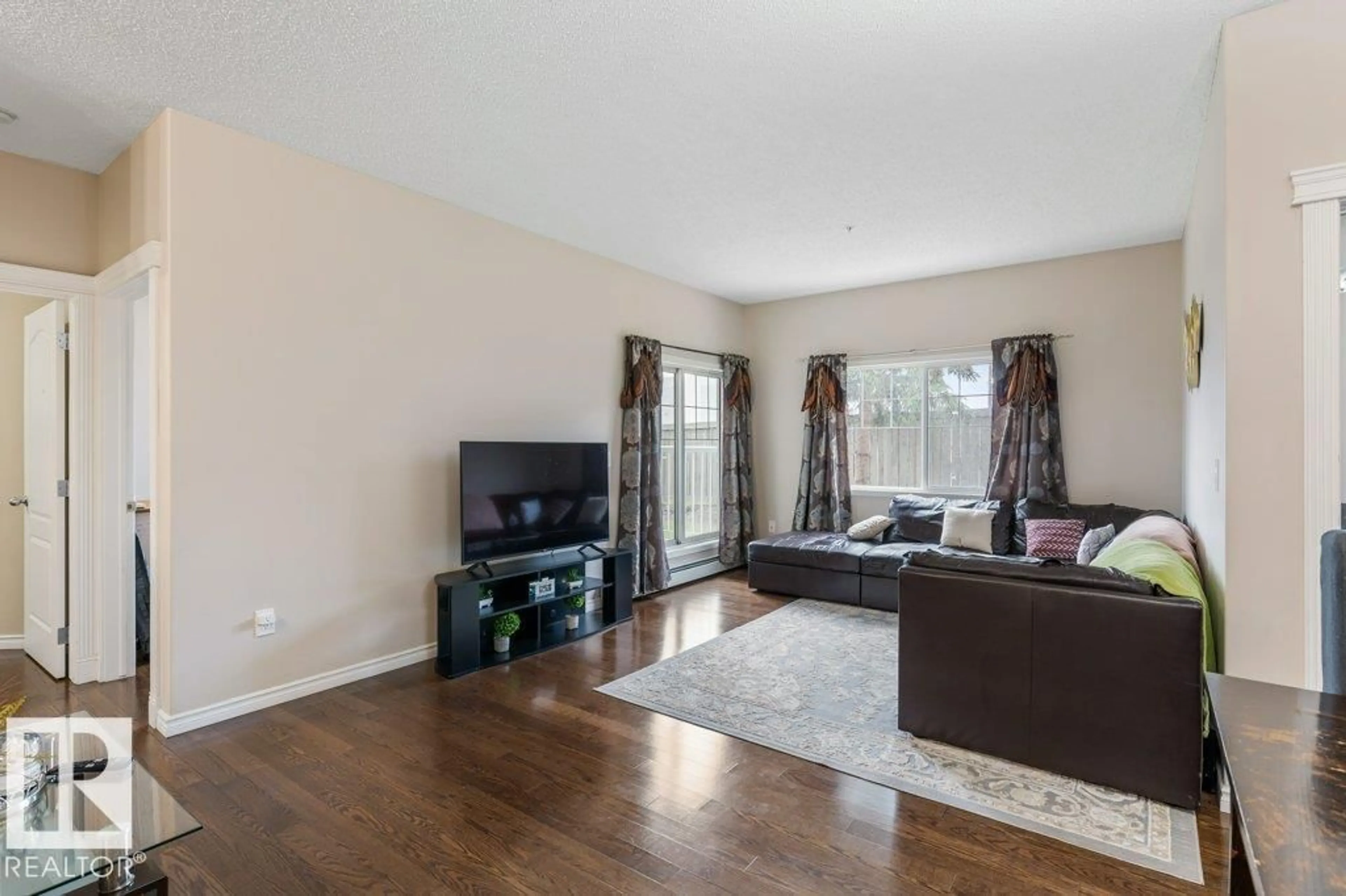 Living room with furniture, wood/laminate floor for #135 - 16807 100 AV, Edmonton Alberta T5P4Z6