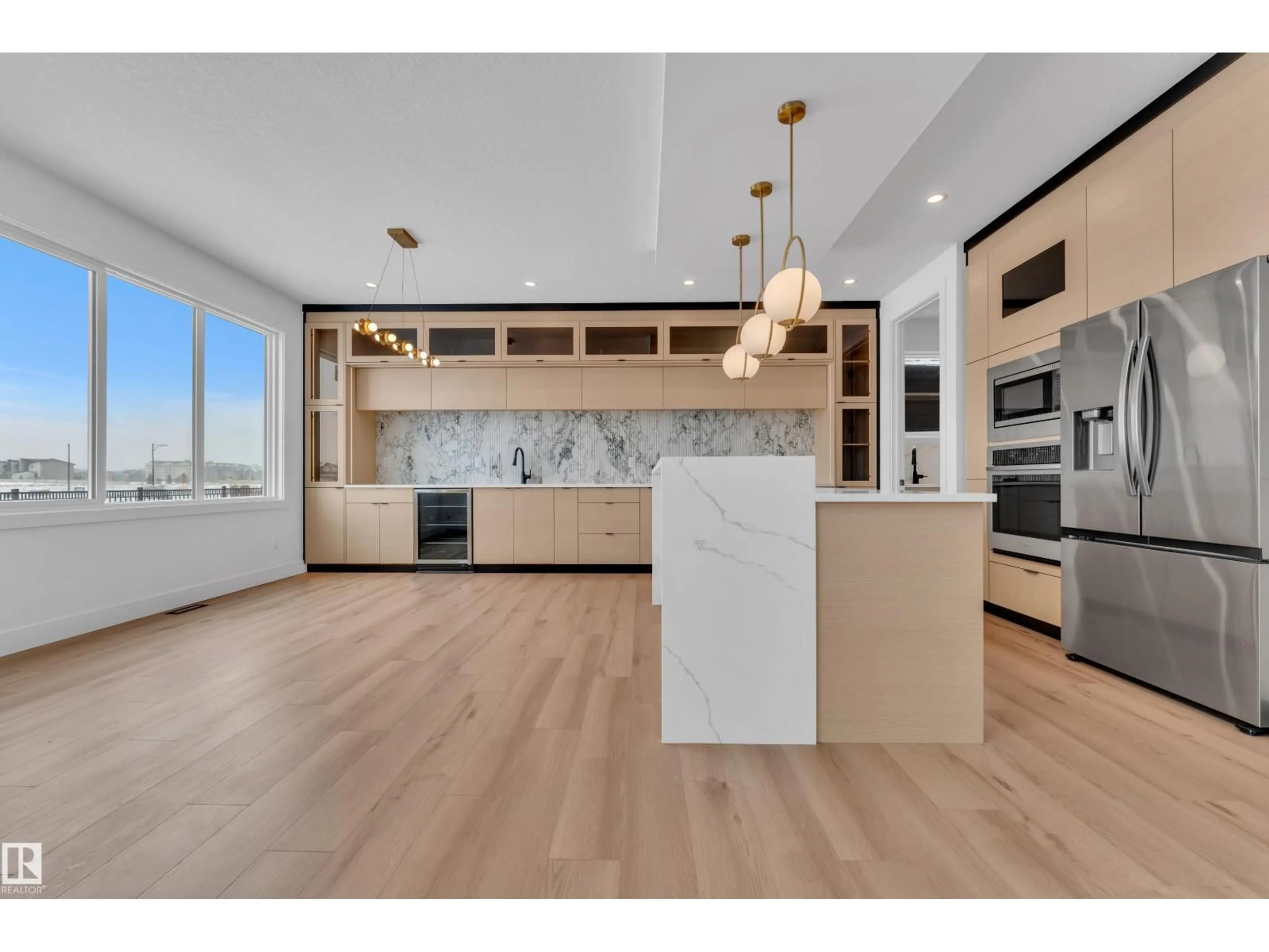 Open concept kitchen, wood/laminate floor for 173 WYATT RG, Fort Saskatchewan Alberta T8L3Y2