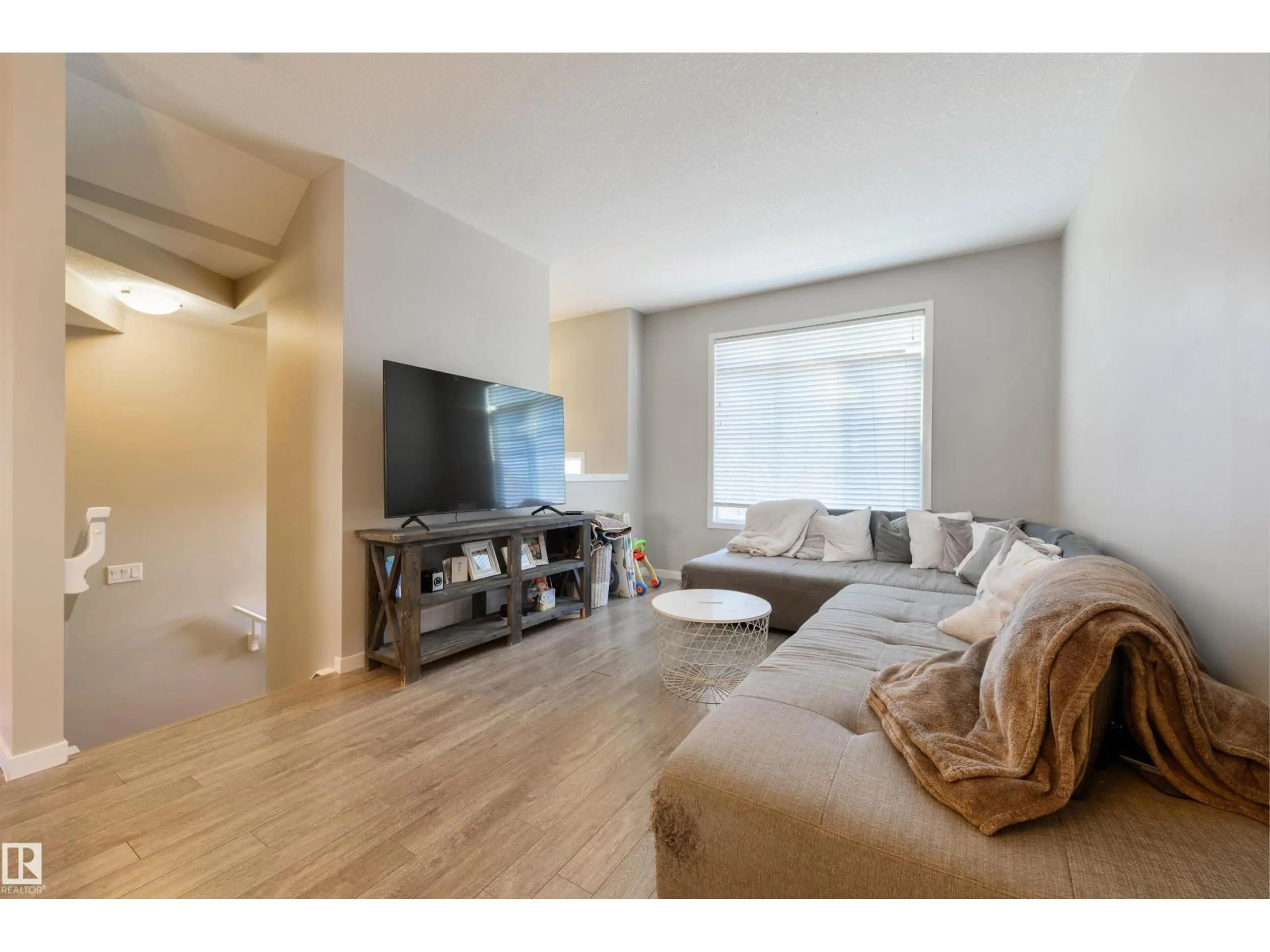 Living room with furniture, wood/laminate floor for #2 - 320 SECORD BV, Edmonton Alberta T5T7E8