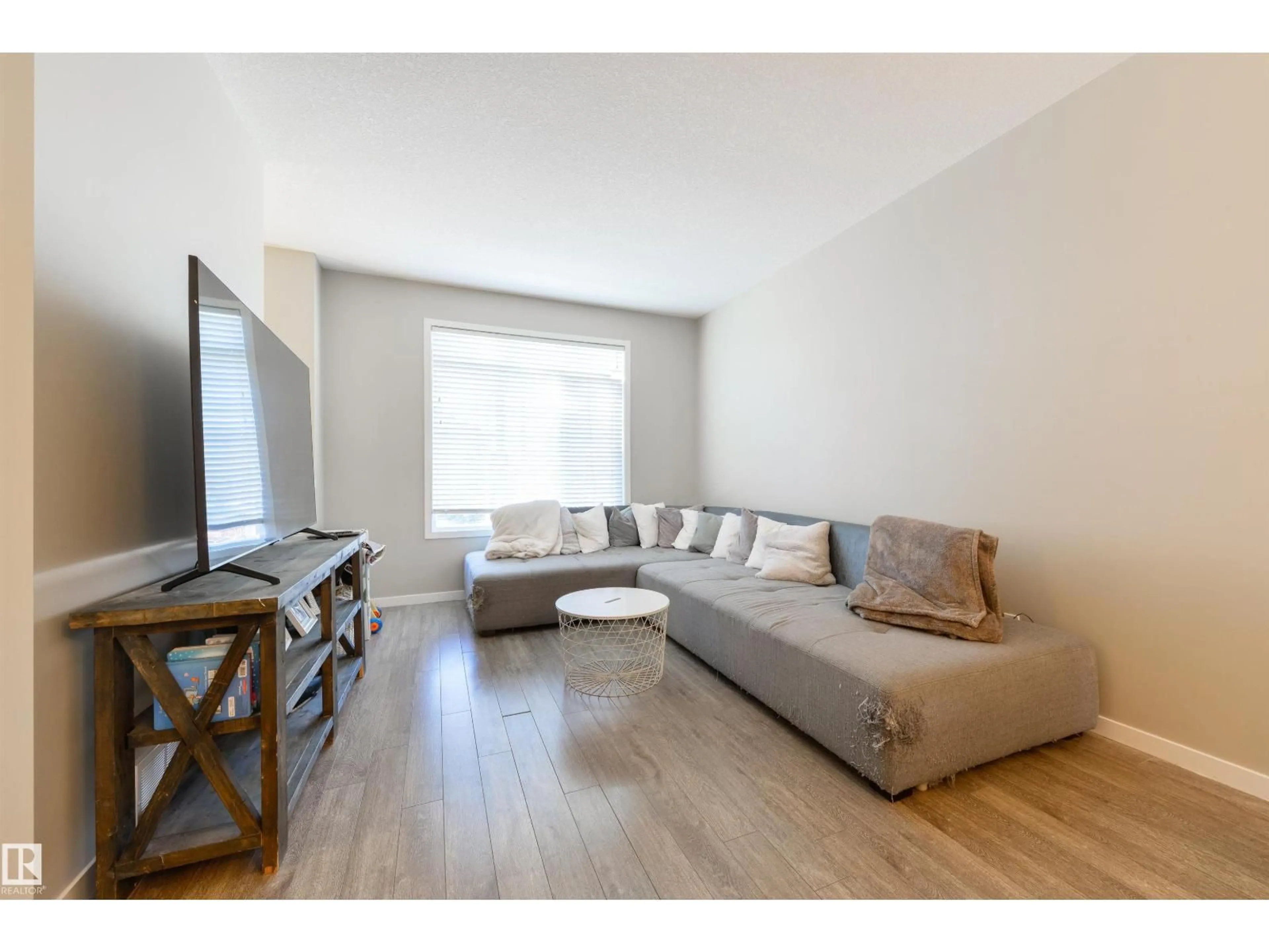 Living room with furniture, wood/laminate floor for #2 - 320 SECORD BV, Edmonton Alberta T5T7E8