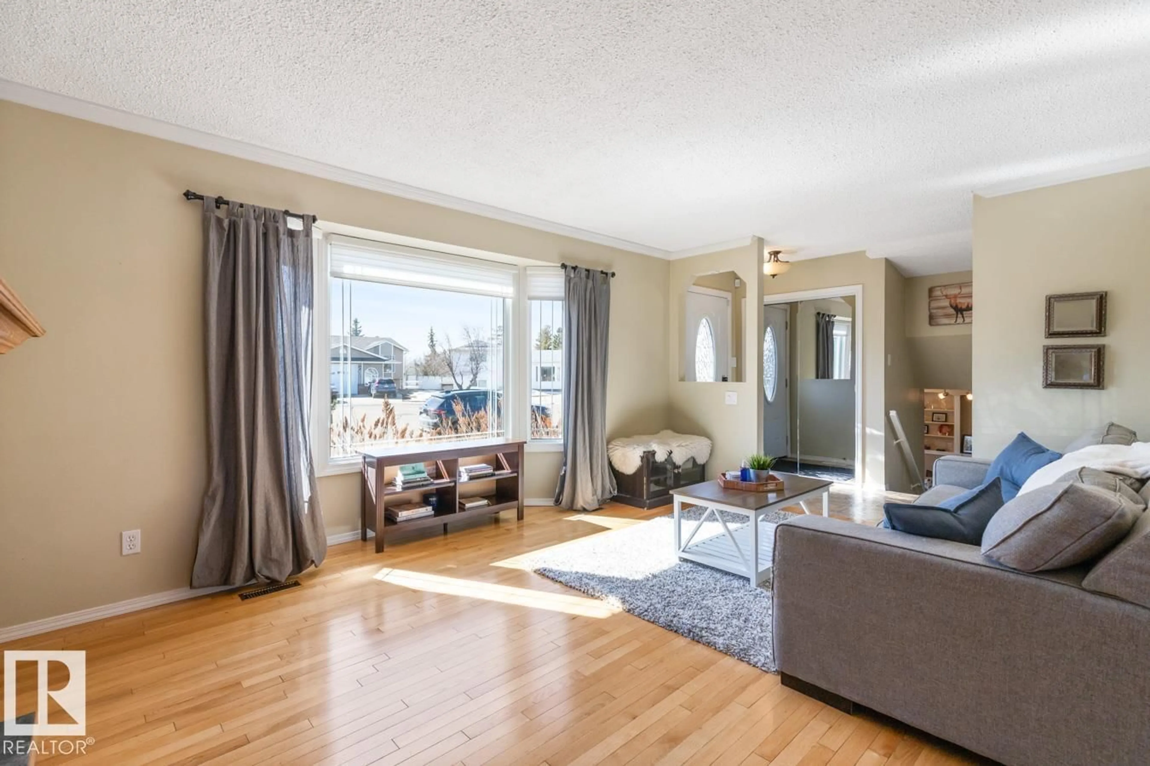 Living room with furniture, wood/laminate floor for NW - 13420 25 ST, Edmonton Alberta T5A3T2