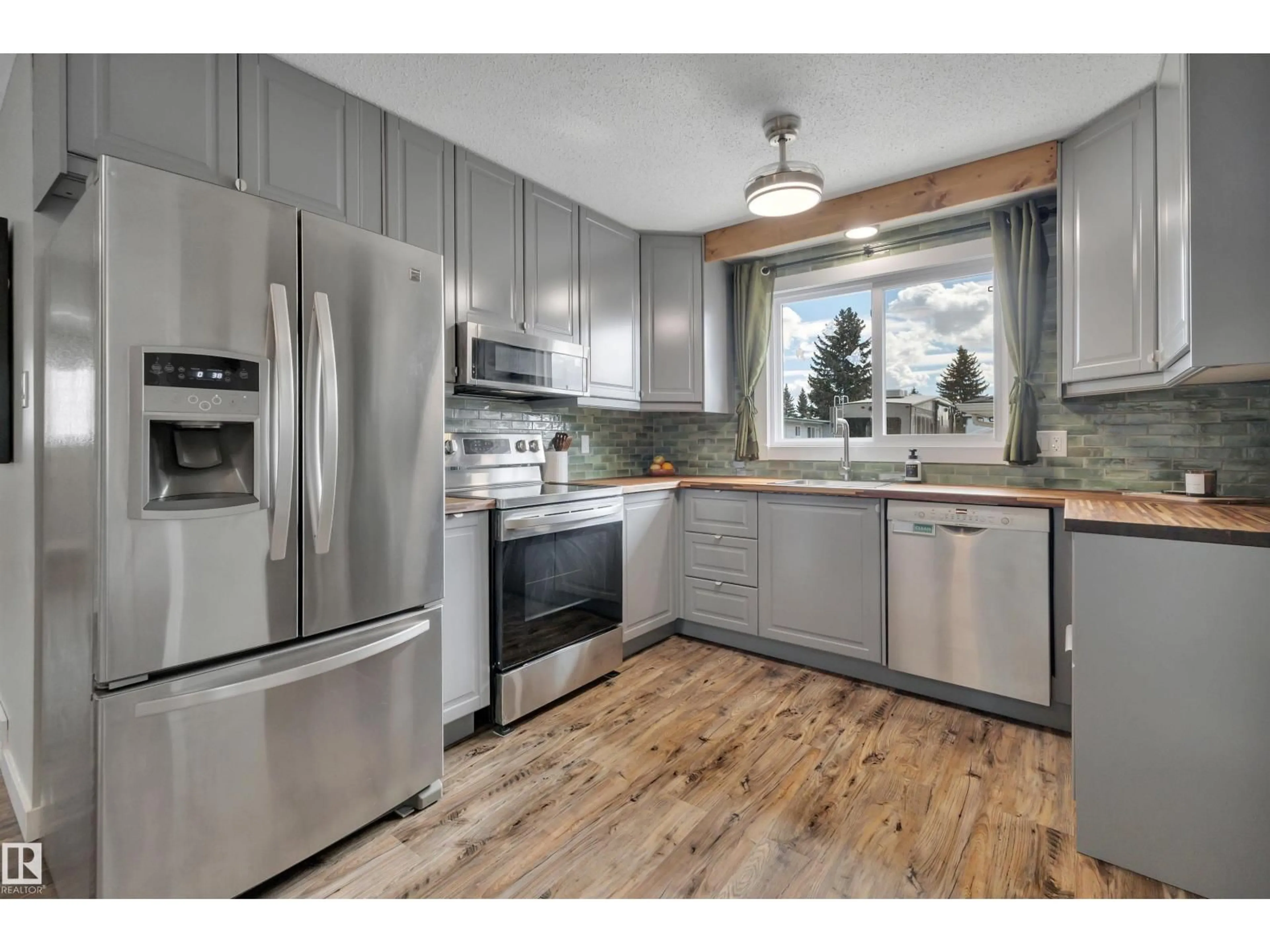Open concept kitchen, wood/laminate floor for 10435 39A AV, Edmonton Alberta T6J2J5