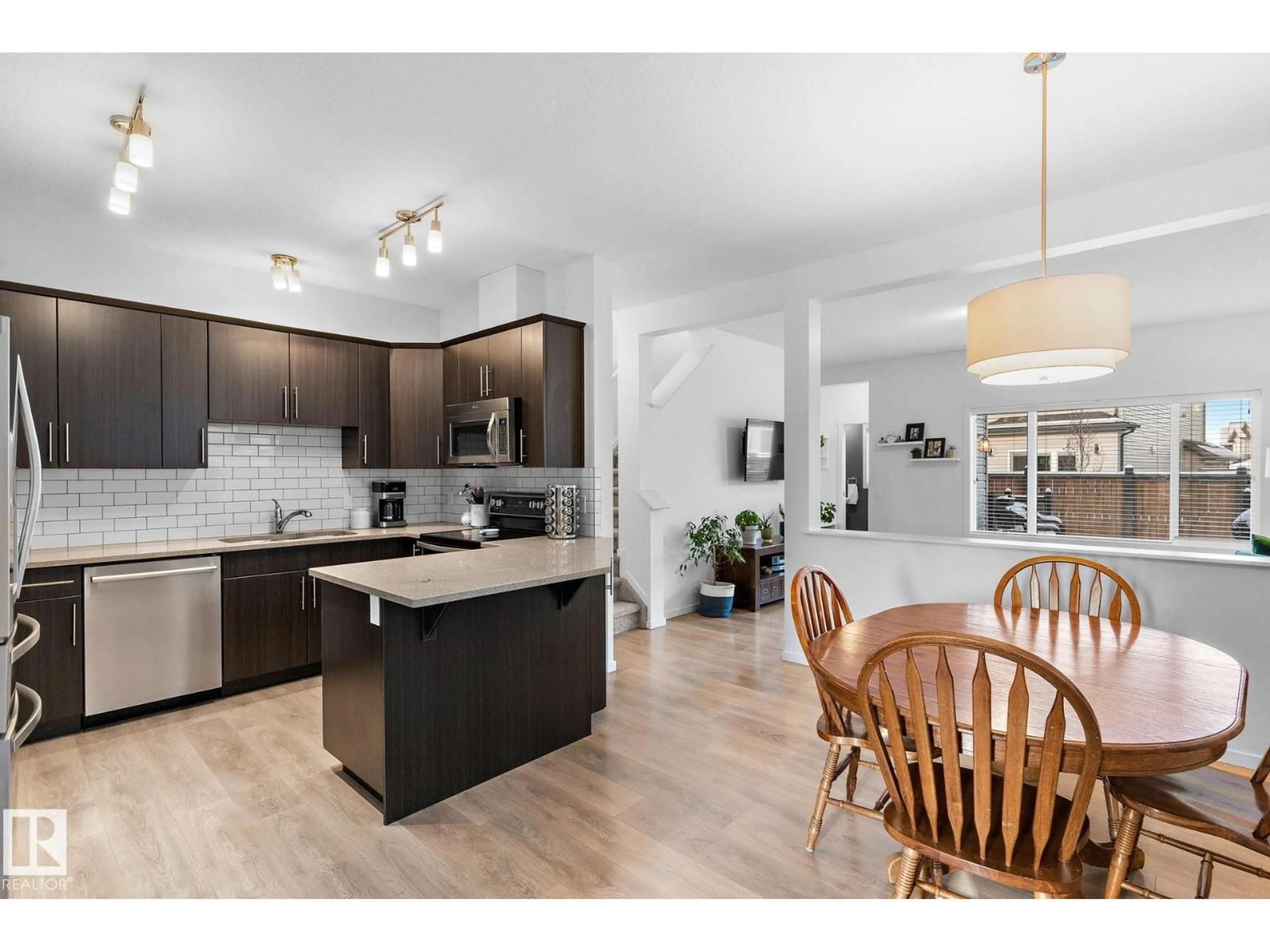 Open concept kitchen, wood/laminate floor for 76 ABBEY RD, Sherwood Park Alberta T8H0Z1