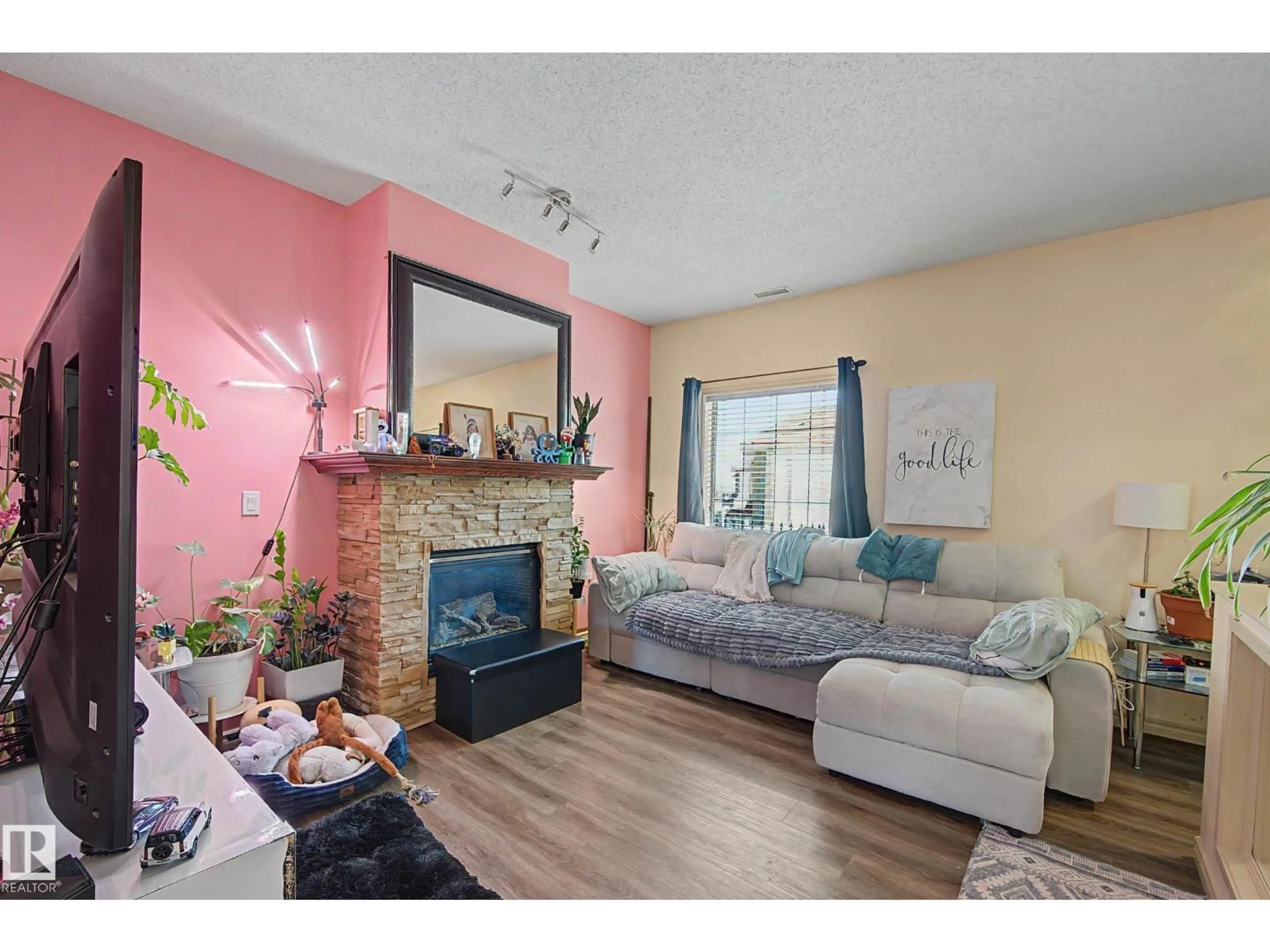 Living room with furniture, wood/laminate floor for 92 - 13825 155 AV, Edmonton Alberta T6V0B8