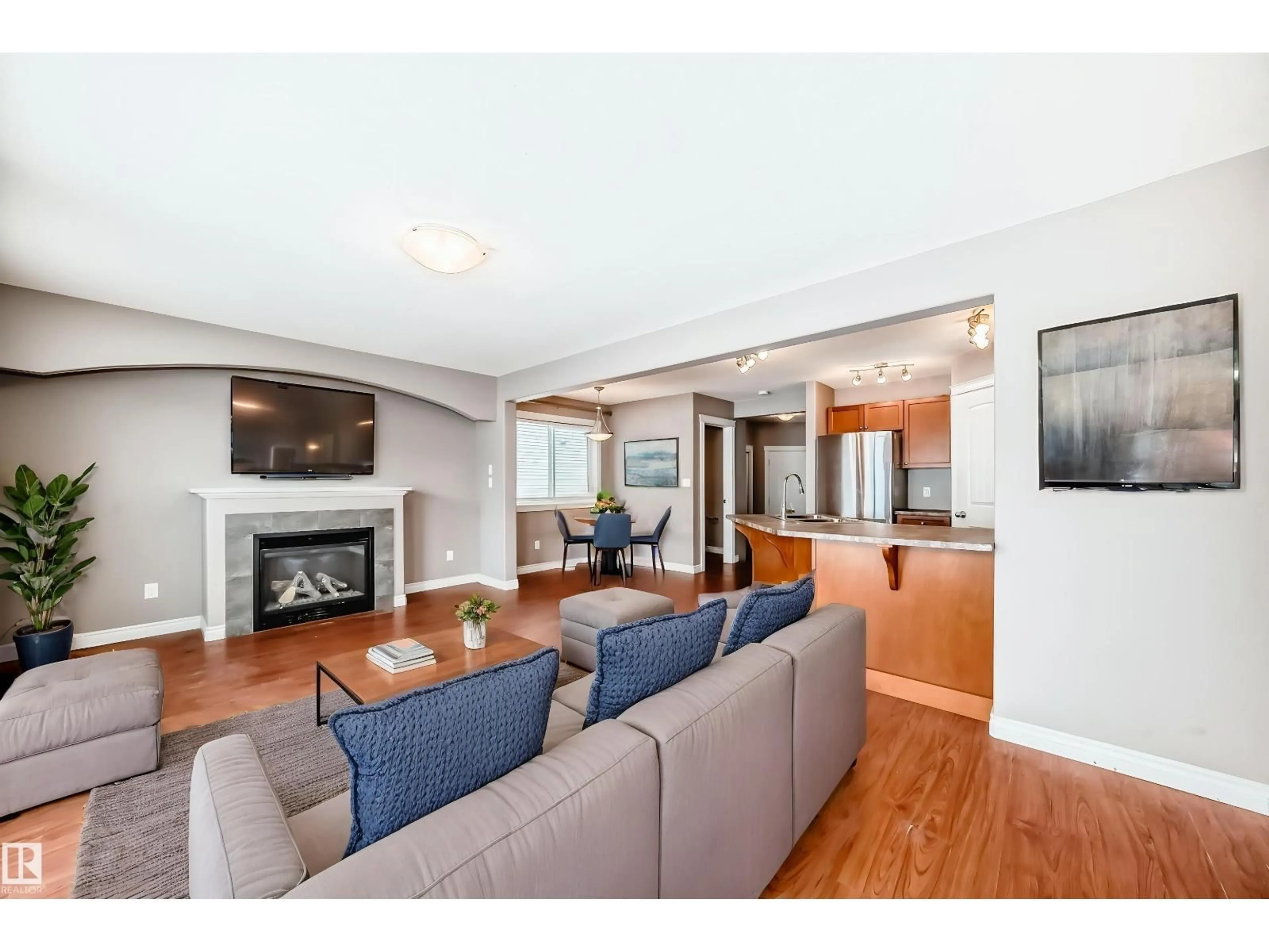 Living room with furniture, wood/laminate floor for NW - 15152 33 ST, Edmonton Alberta T5Y0J7