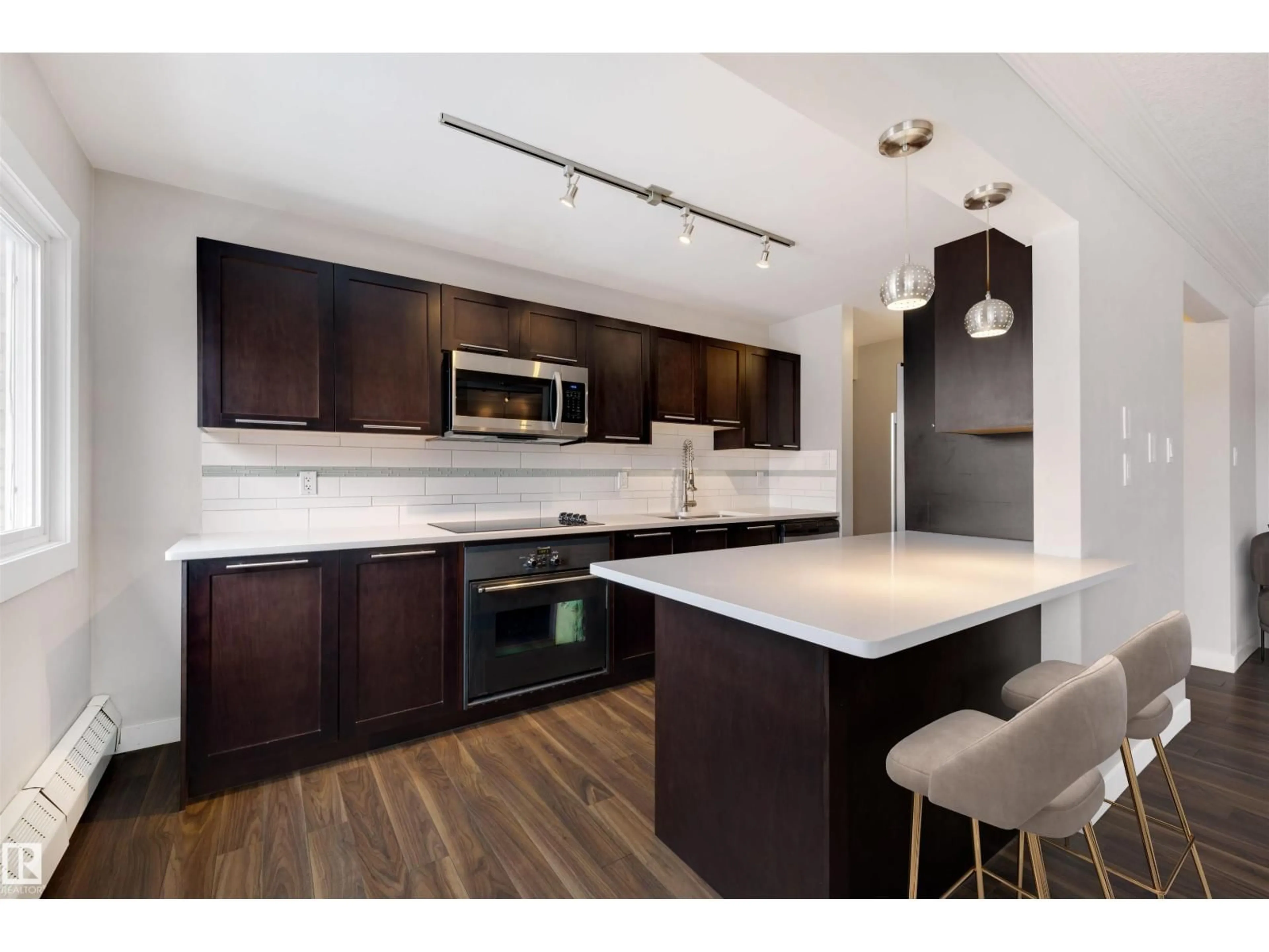 Open concept kitchen, wood/laminate floor for #32 - 10015 83 AV, Edmonton Alberta T6E2C3
