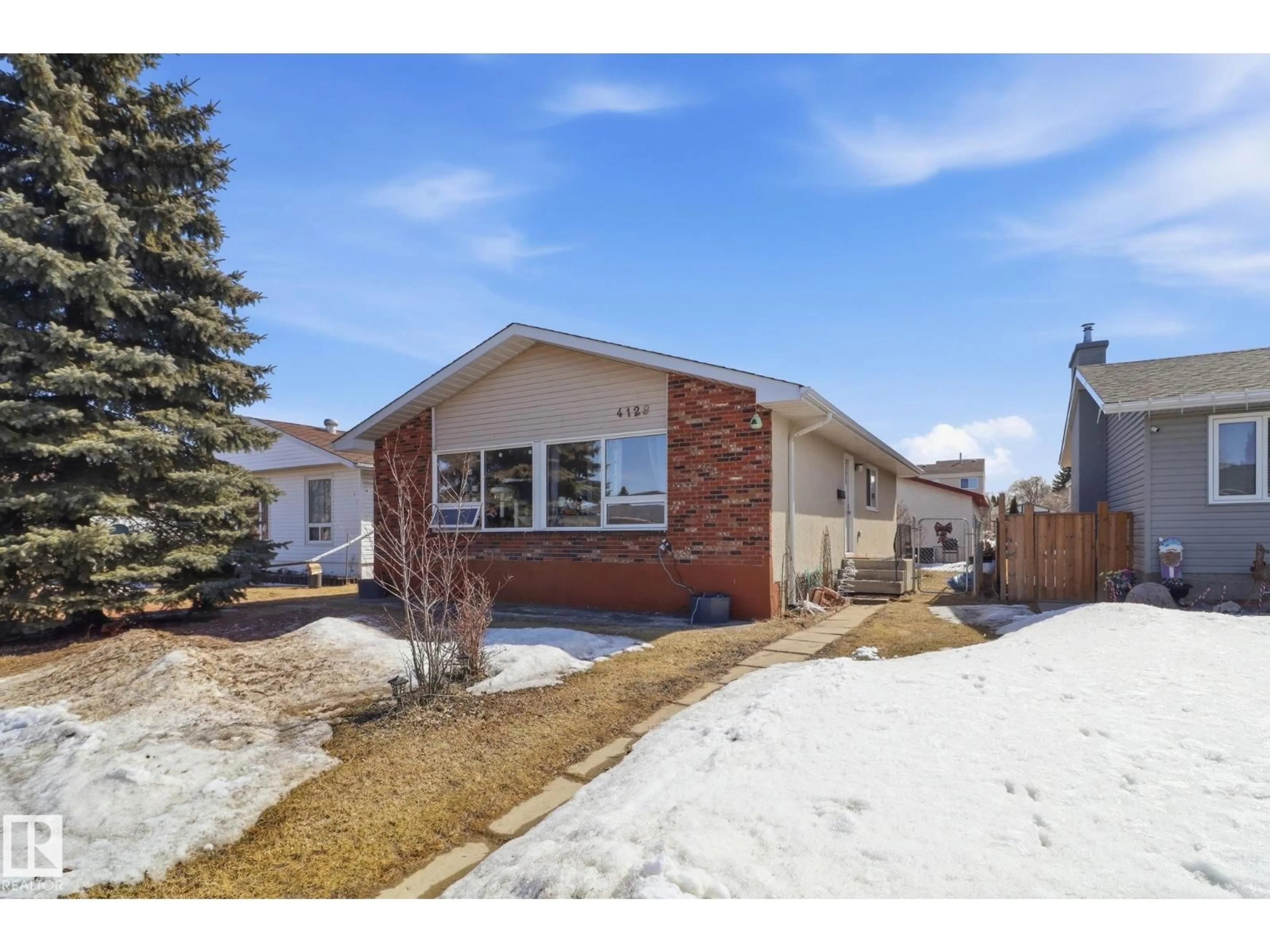 Home with brick exterior material, street for NW - 4129 134A AV, Edmonton Alberta T5A2N2