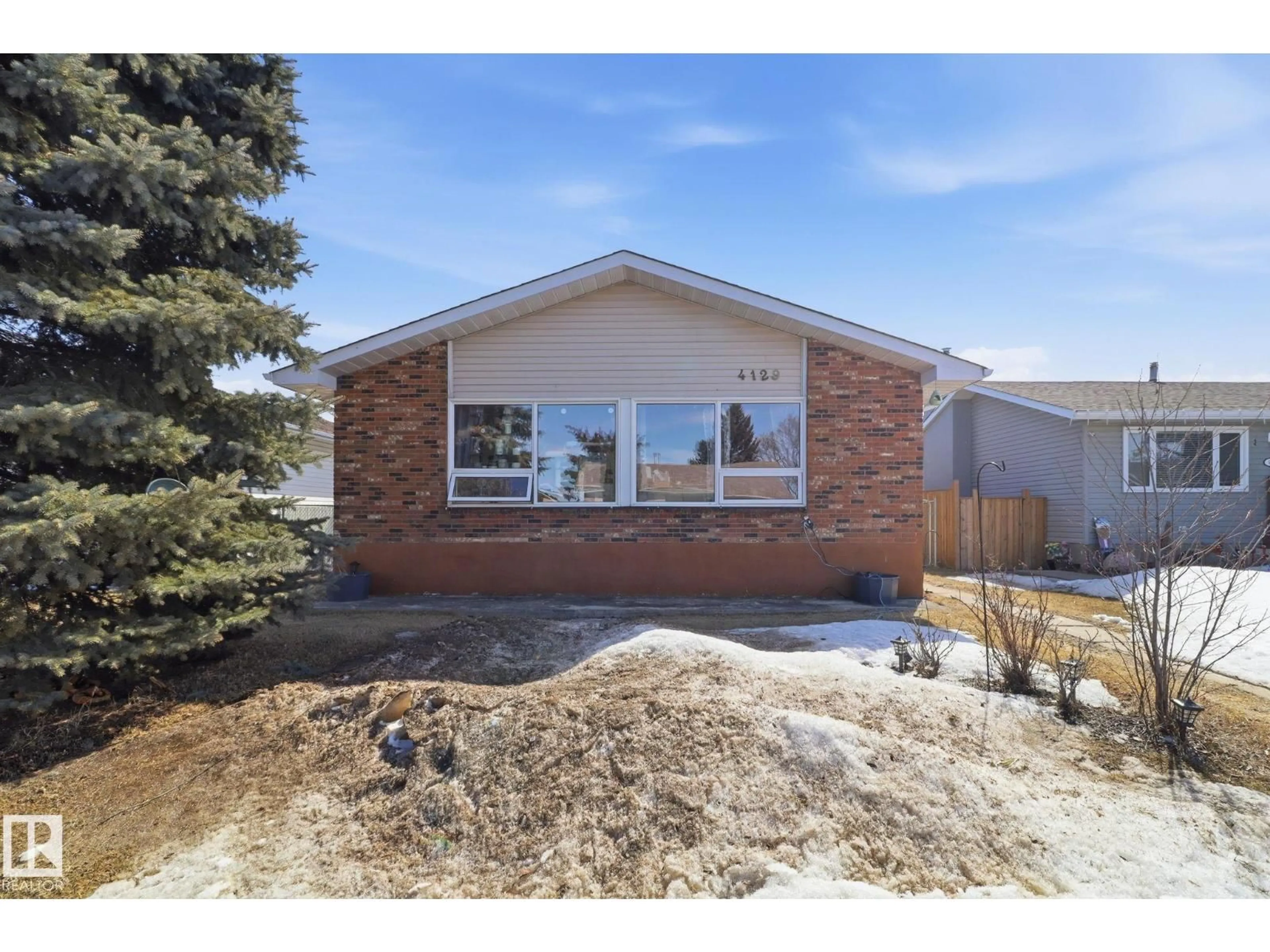 Home with brick exterior material, street for NW - 4129 134A AV, Edmonton Alberta T5A2N2