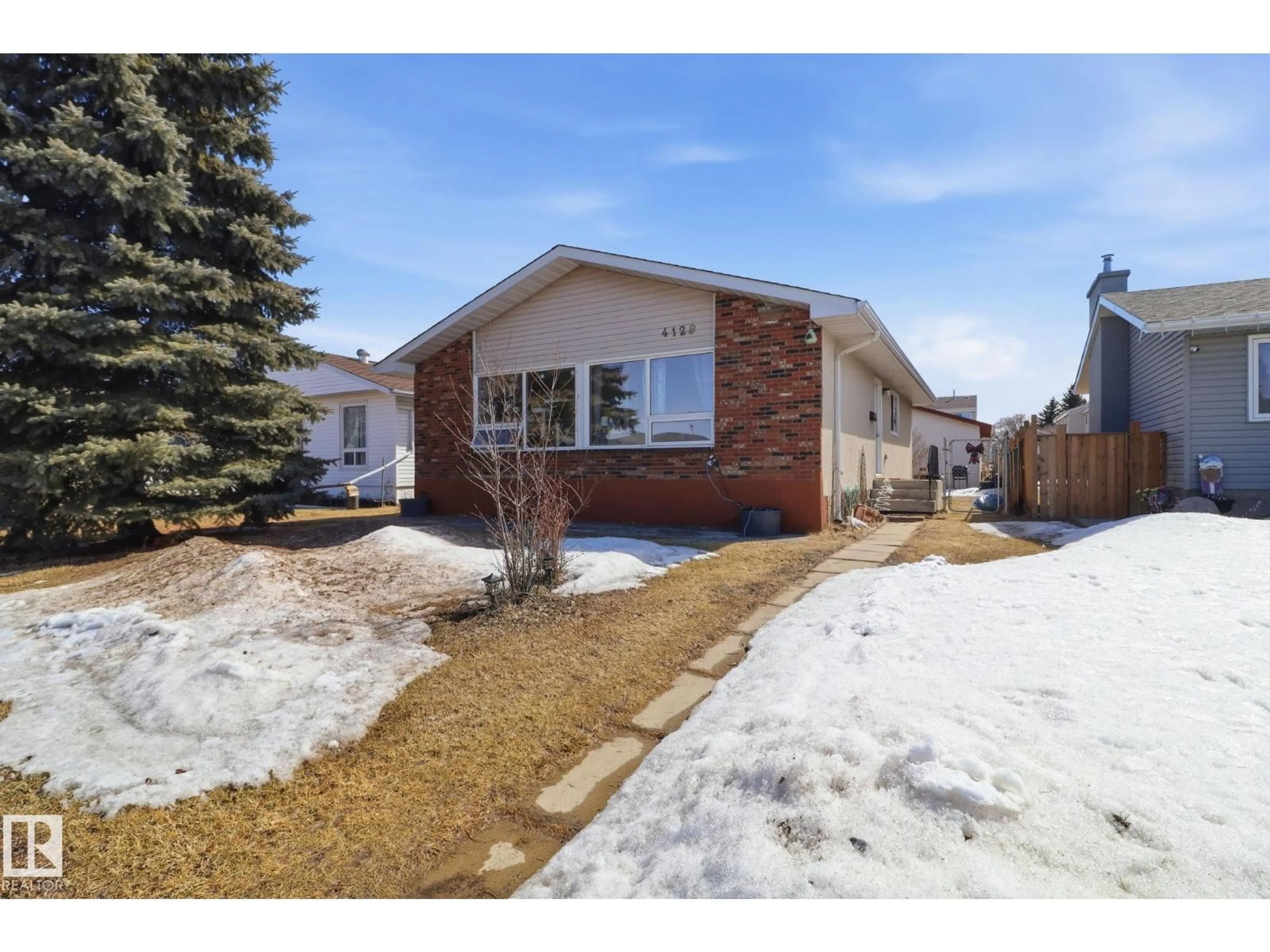 Home with brick exterior material, street for NW - 4129 134A AV, Edmonton Alberta T5A2N2