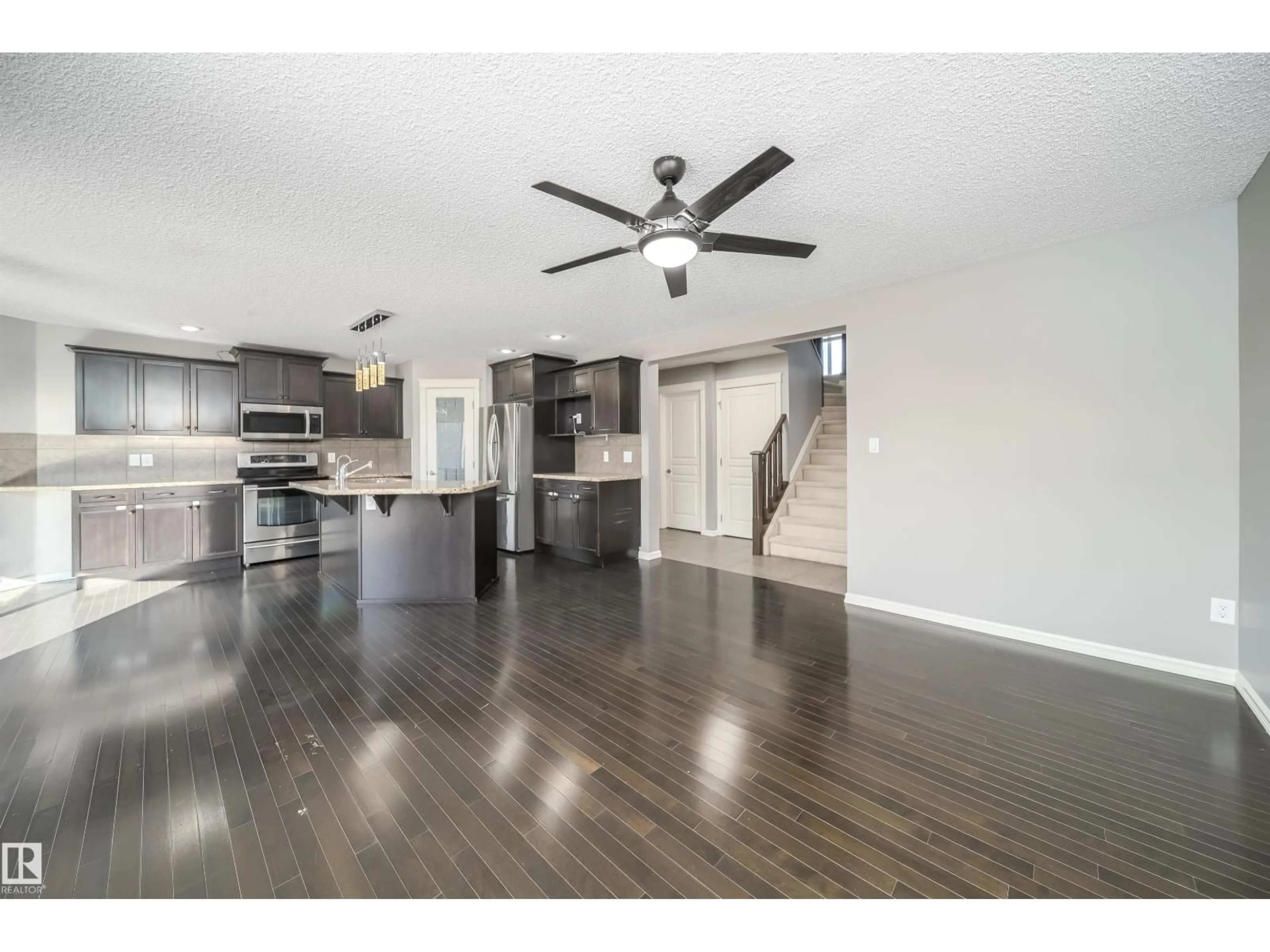 Open concept kitchen, wood/laminate floor for 5935 6 AV, Edmonton Alberta T6X0G4