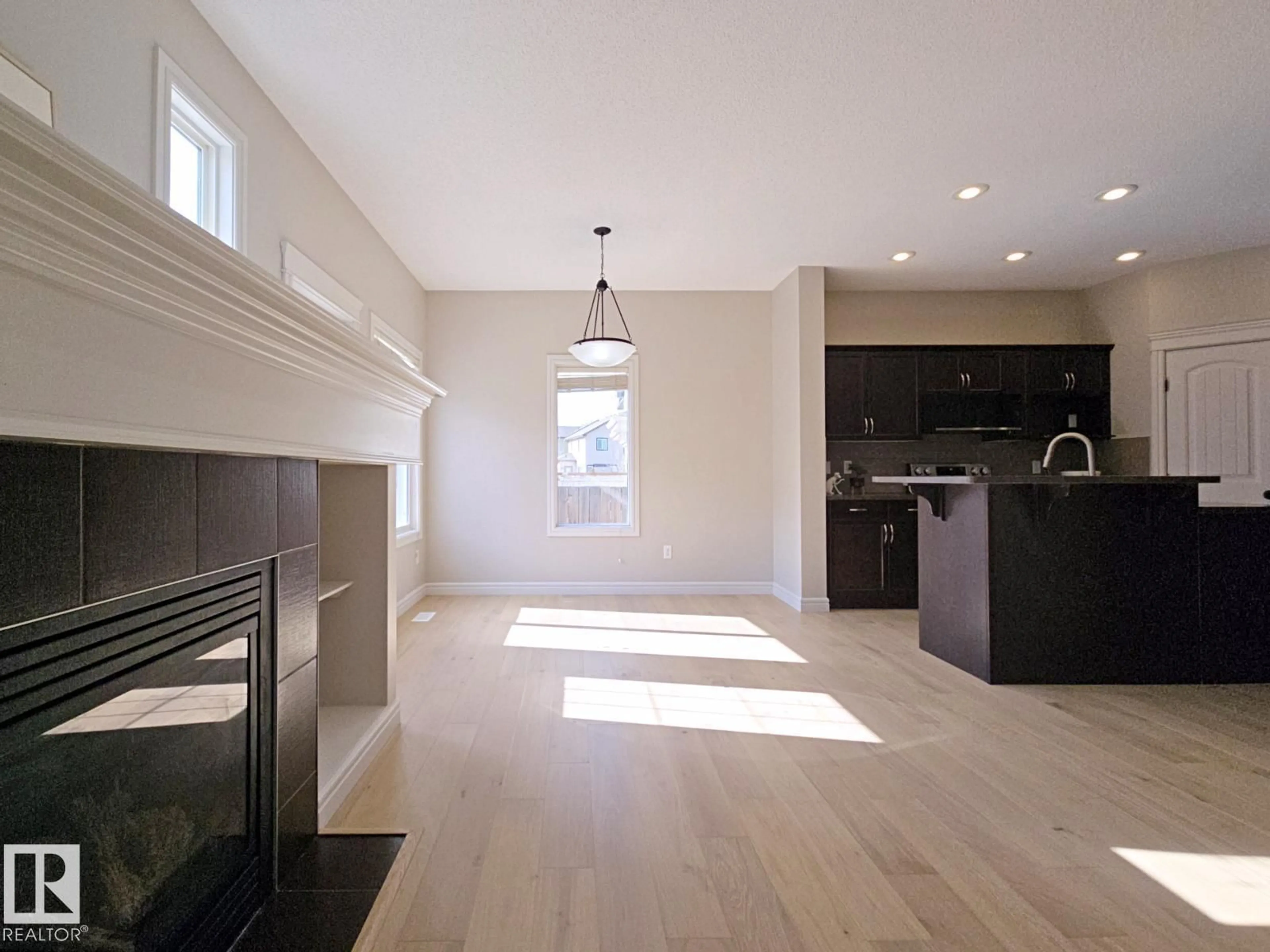 Open concept kitchen, wood/laminate floor for SW - 11525 18A AV, Edmonton Alberta T6W2E6