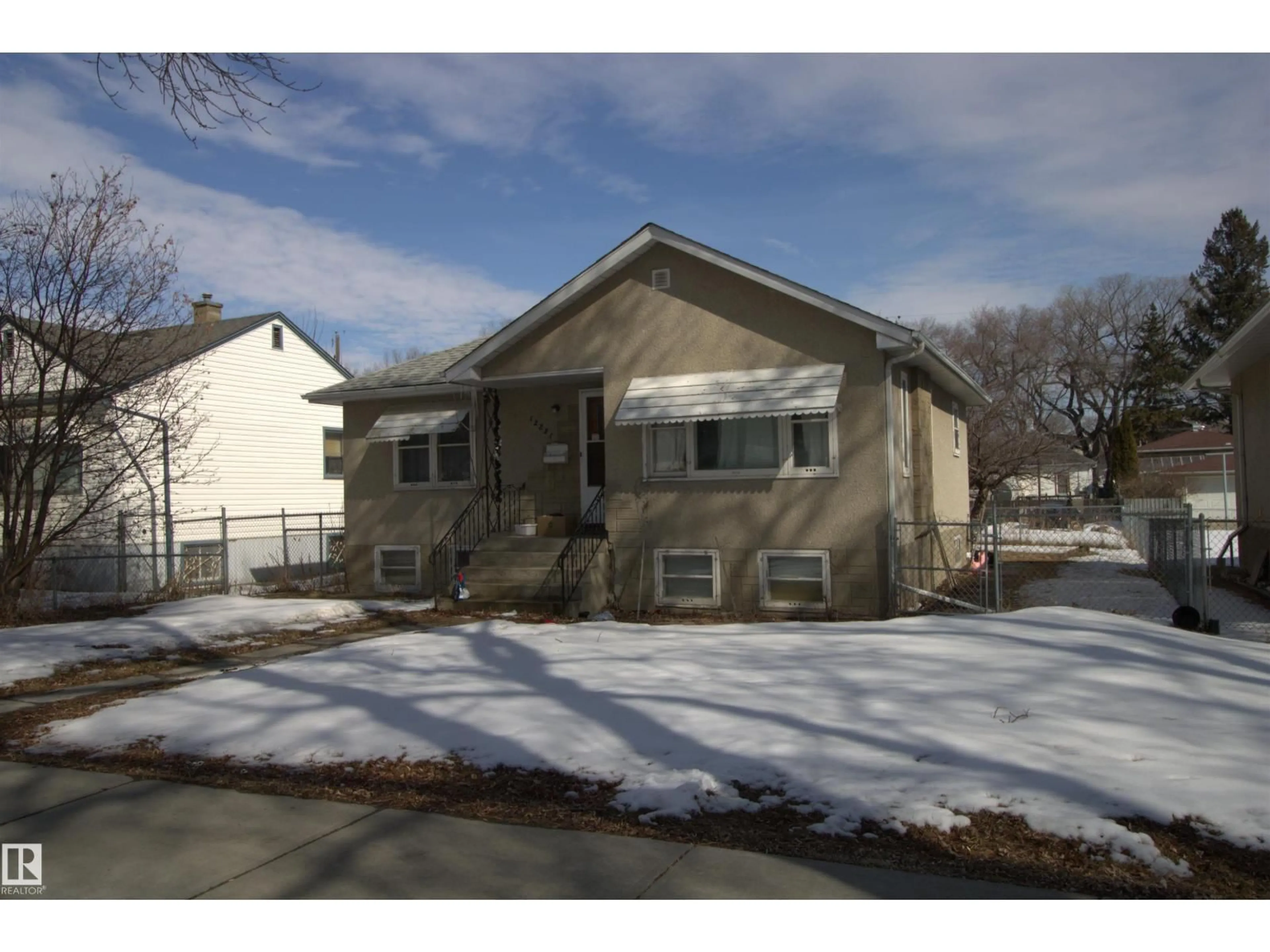 Home with vinyl exterior material, street for 12221 94 ST, Edmonton Alberta T5G1K2