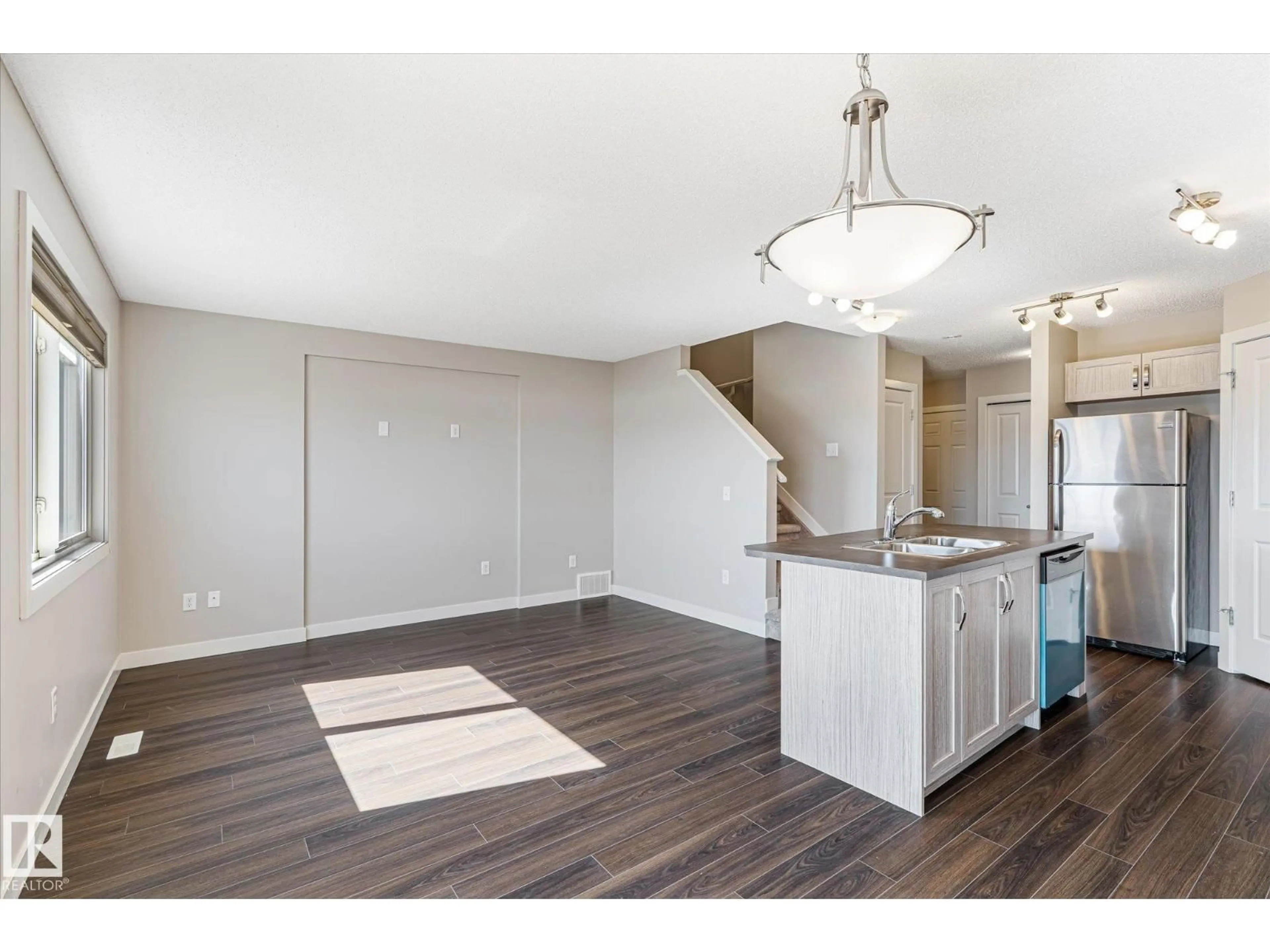 Open concept kitchen, wood/laminate floor for 3217 11 AV, Edmonton Alberta T6T2C5