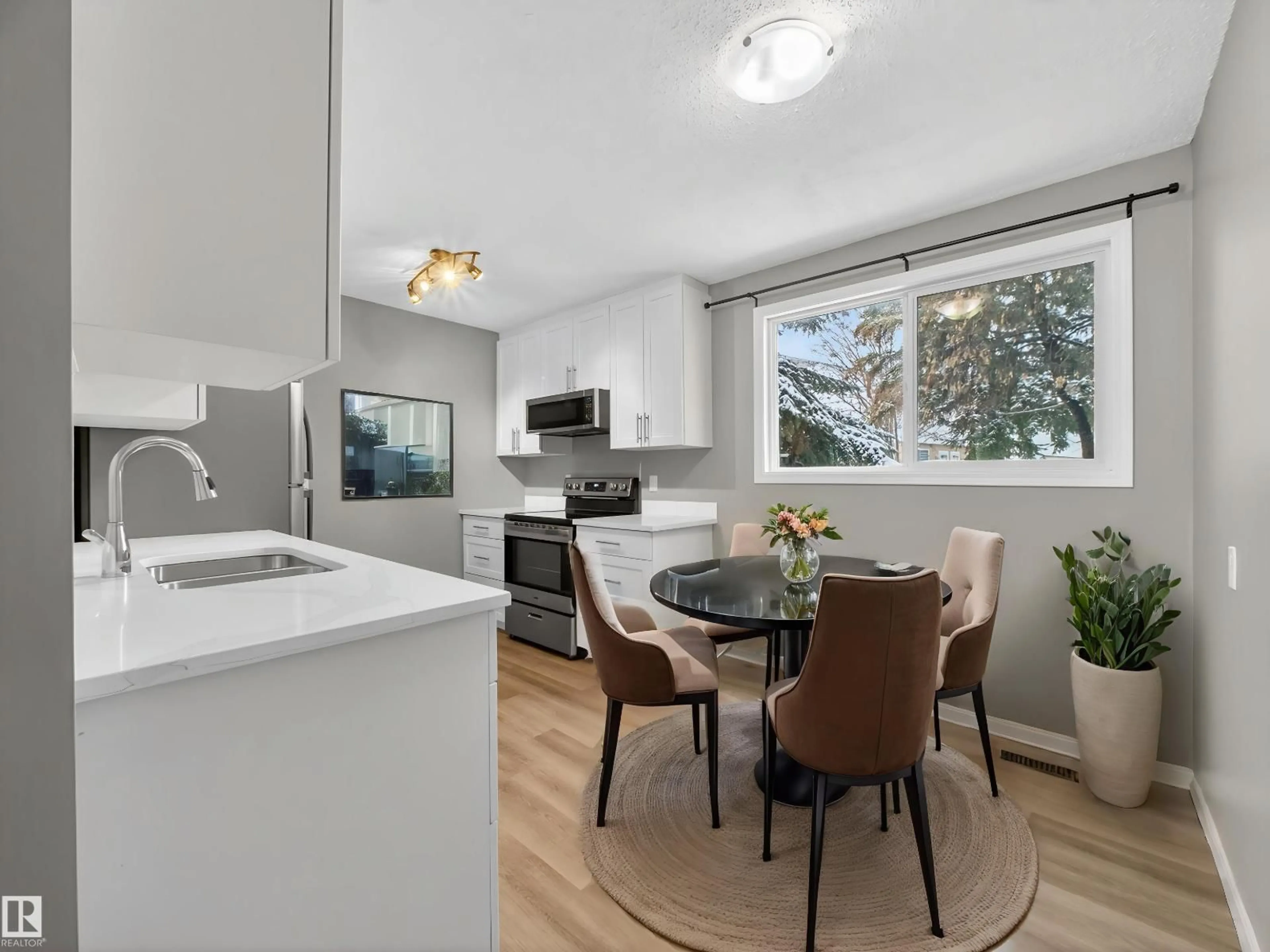 Open concept kitchen, wood/laminate floor for 7715 37 AV, Edmonton Alberta T6K1T9