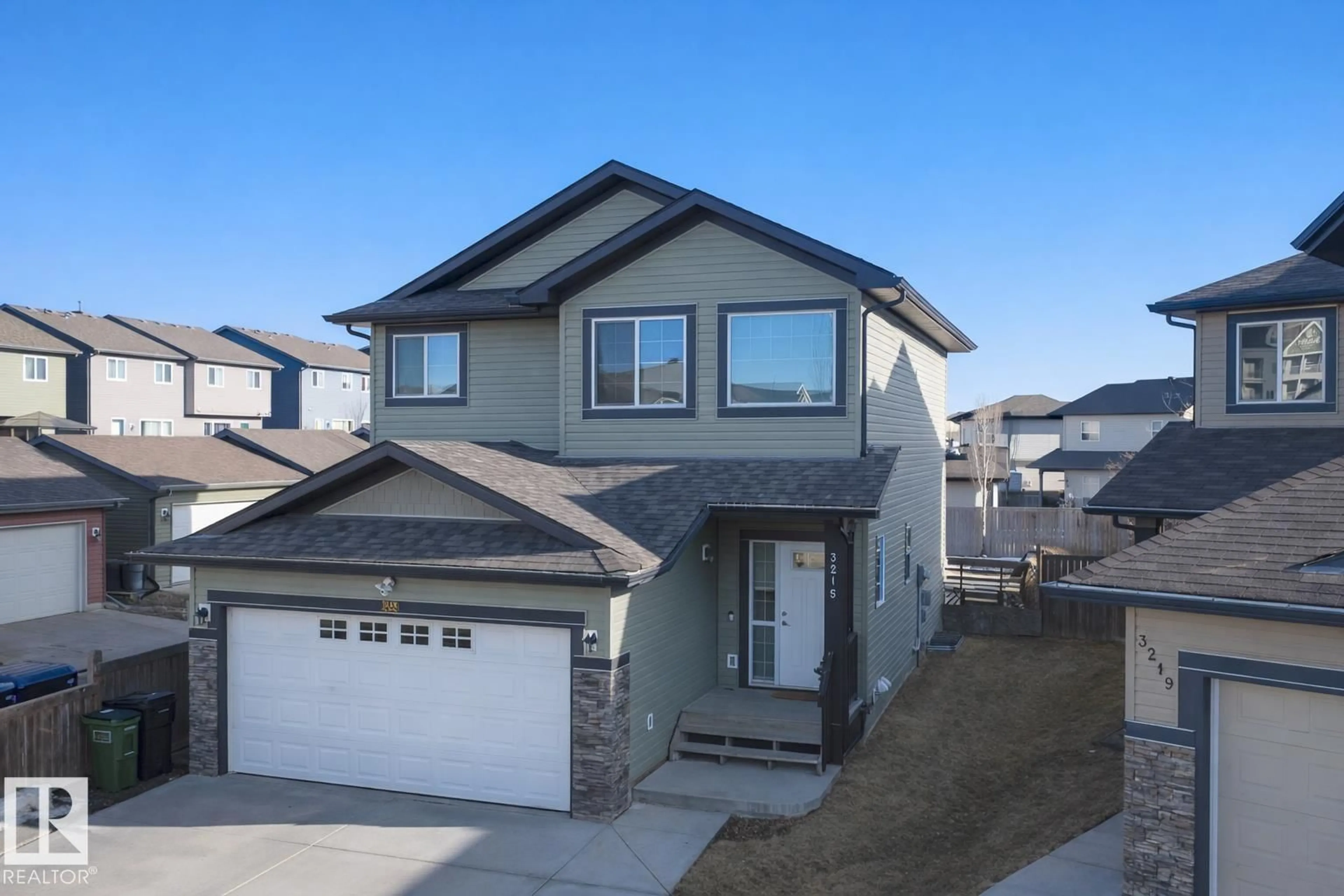 Home with vinyl exterior material, street for 3215 22 AV, Edmonton Alberta T6T0K6