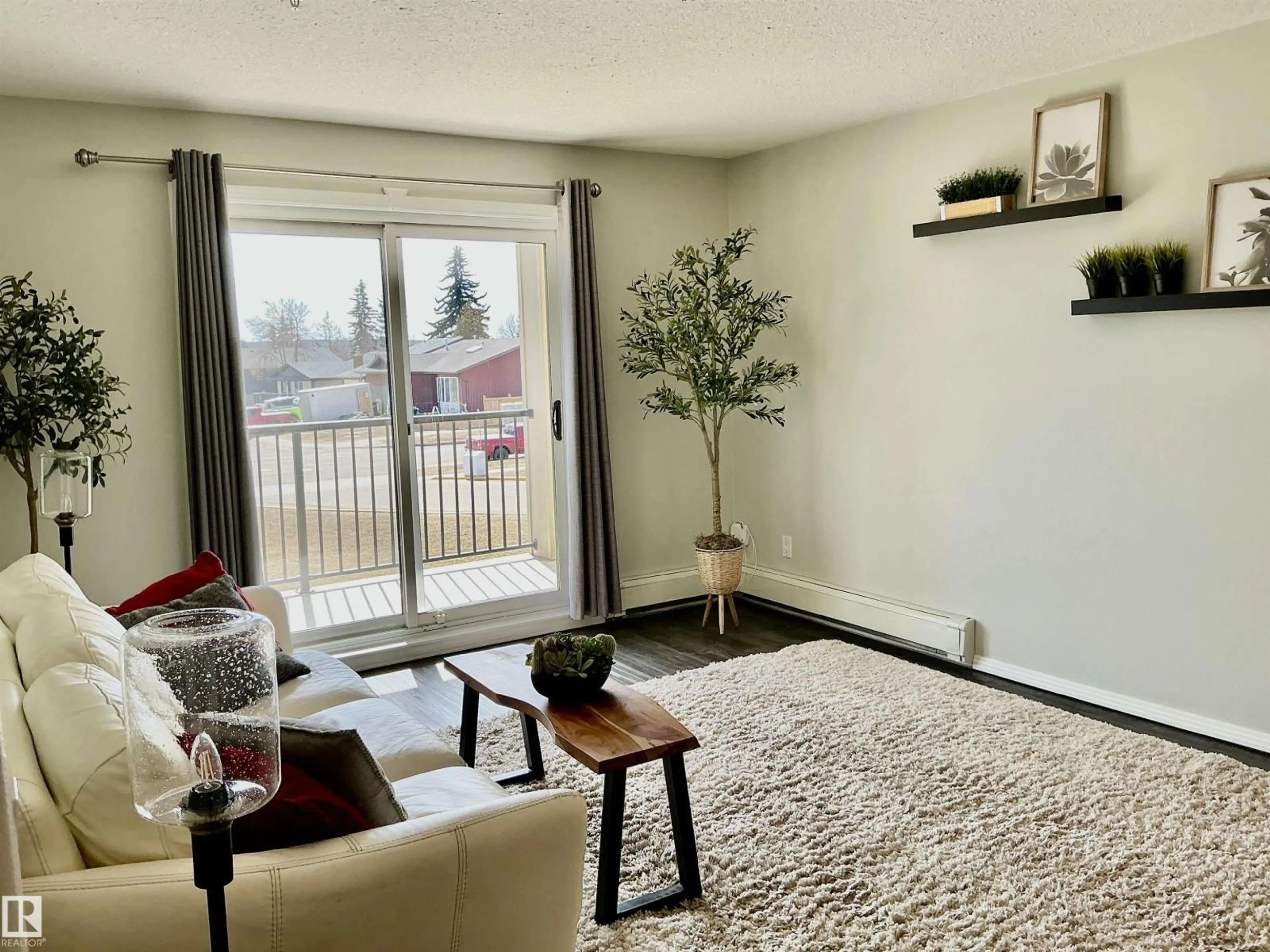 Living room with furniture, unknown for #207 - 592 HOOKE RD, Edmonton Alberta T5A5H2