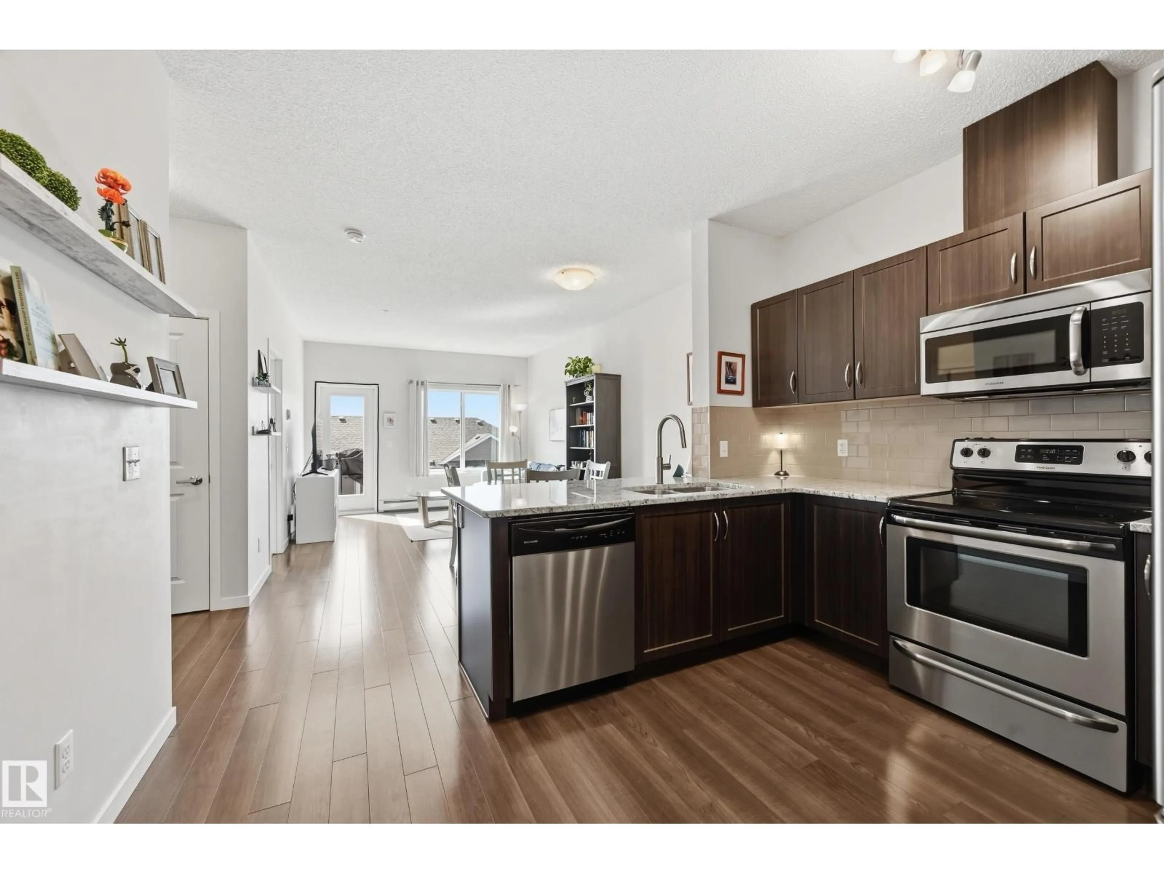 Open concept kitchen, wood/laminate floor for #421 - 1820 RUTHERFORD RD, Edmonton Alberta T6W2K6