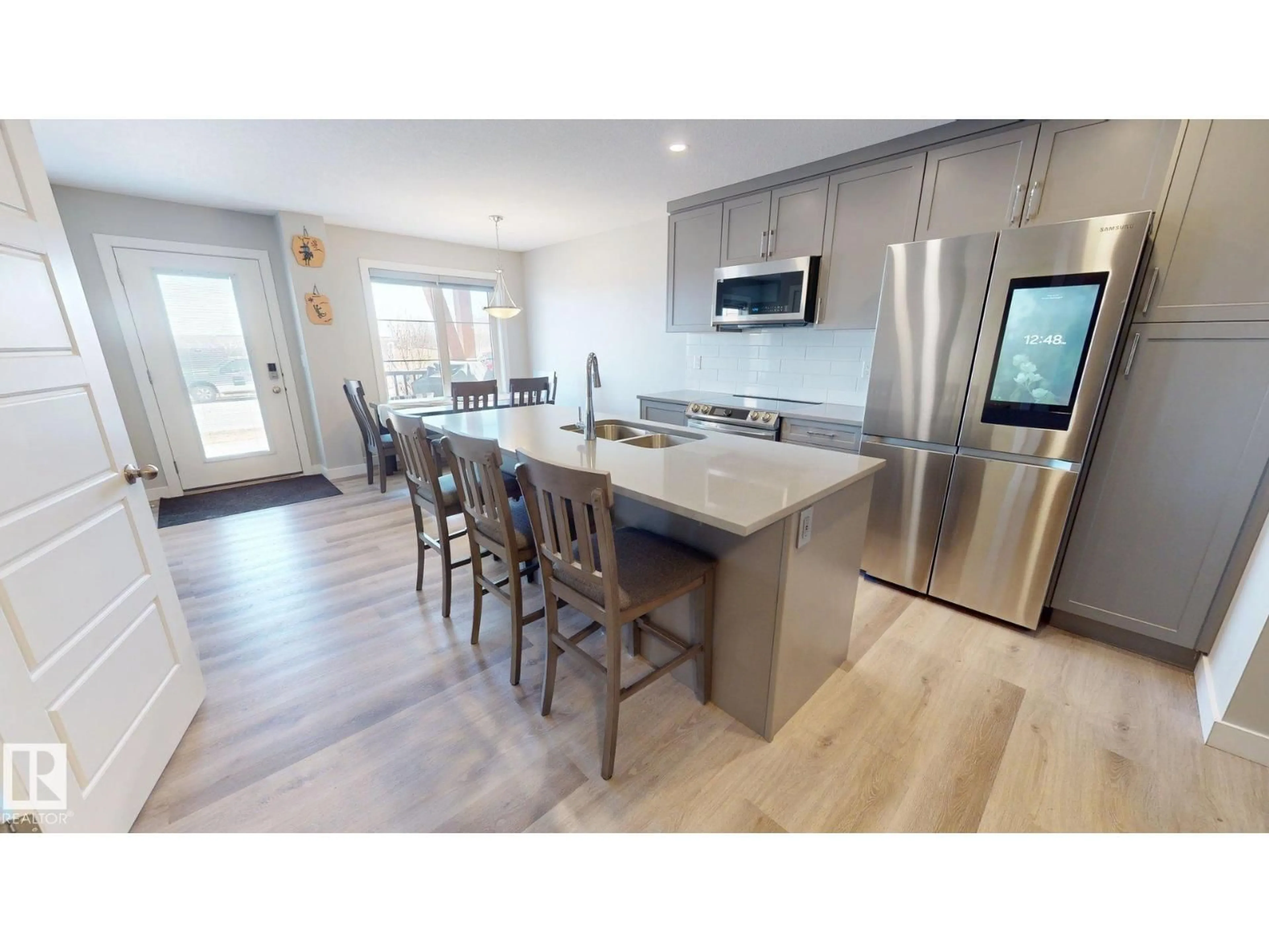 Open concept kitchen, wood/laminate floor for 998 STILLWATER BV, Edmonton Alberta T6M1M8