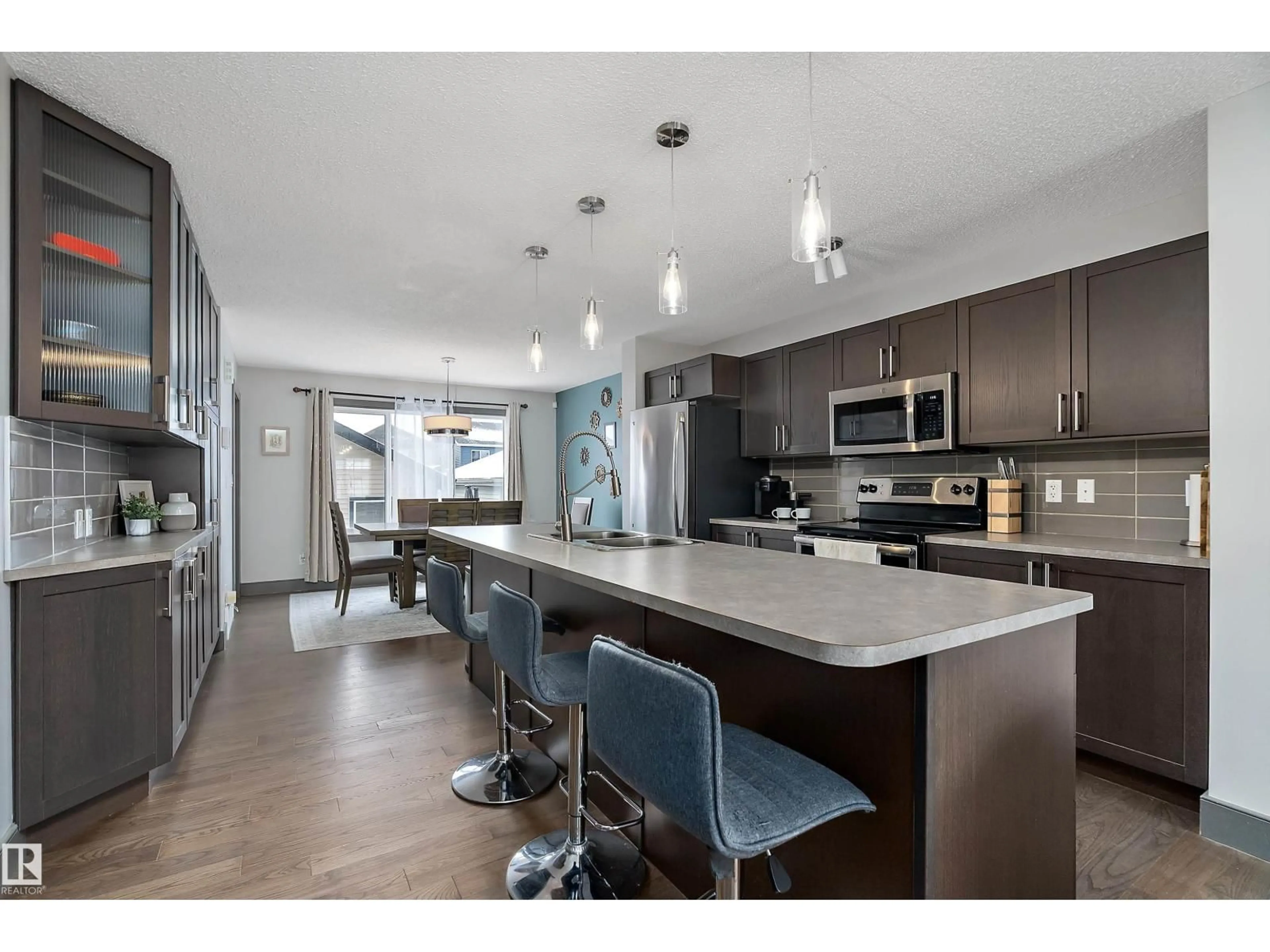 Open concept kitchen, wood/laminate floor for 7776 EIFERT CRESCENT, Edmonton Alberta T6M0W1