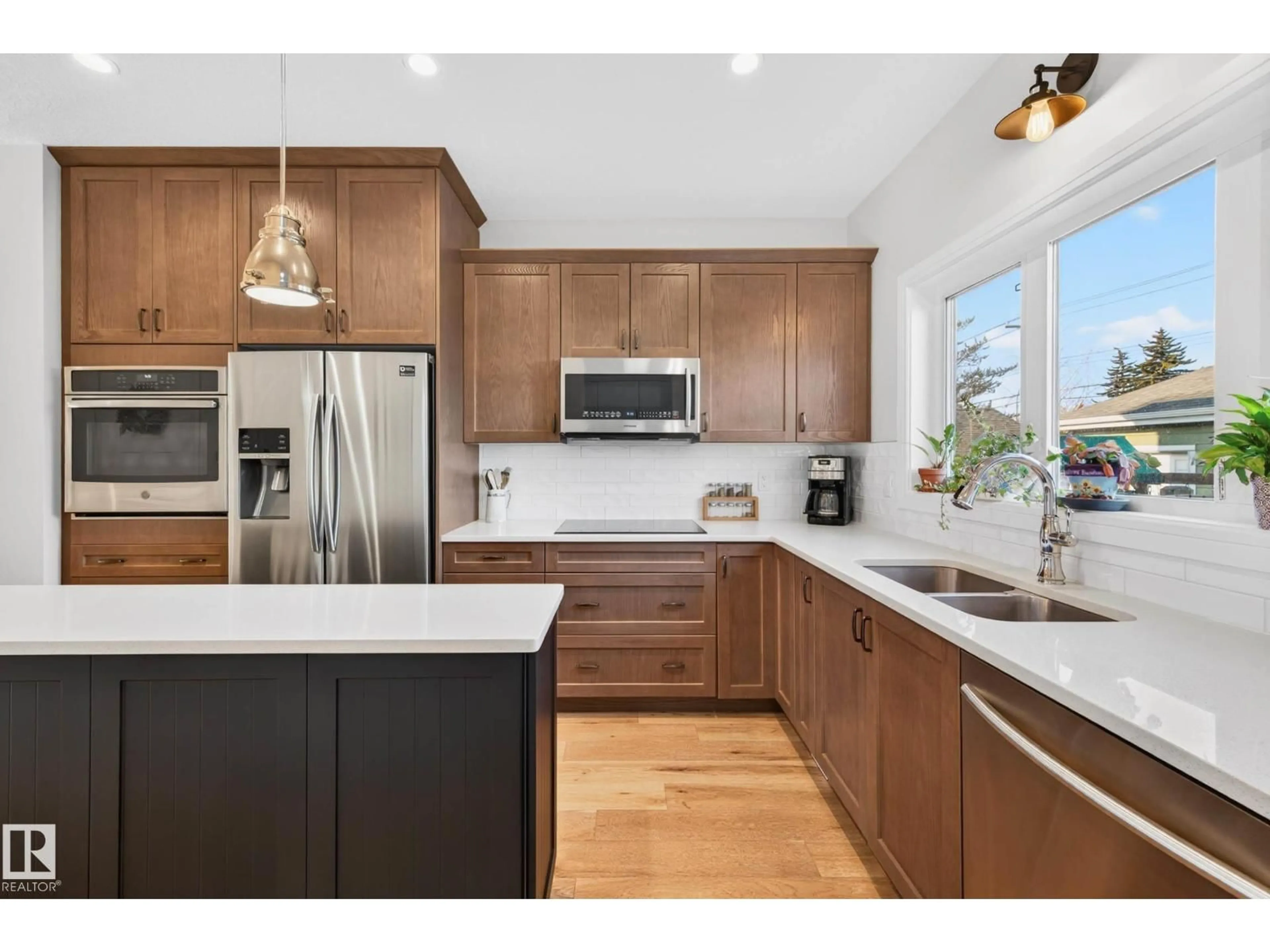 Open concept kitchen, wood/laminate floor for NW - 10972 141 ST, Edmonton Alberta T5M1T4