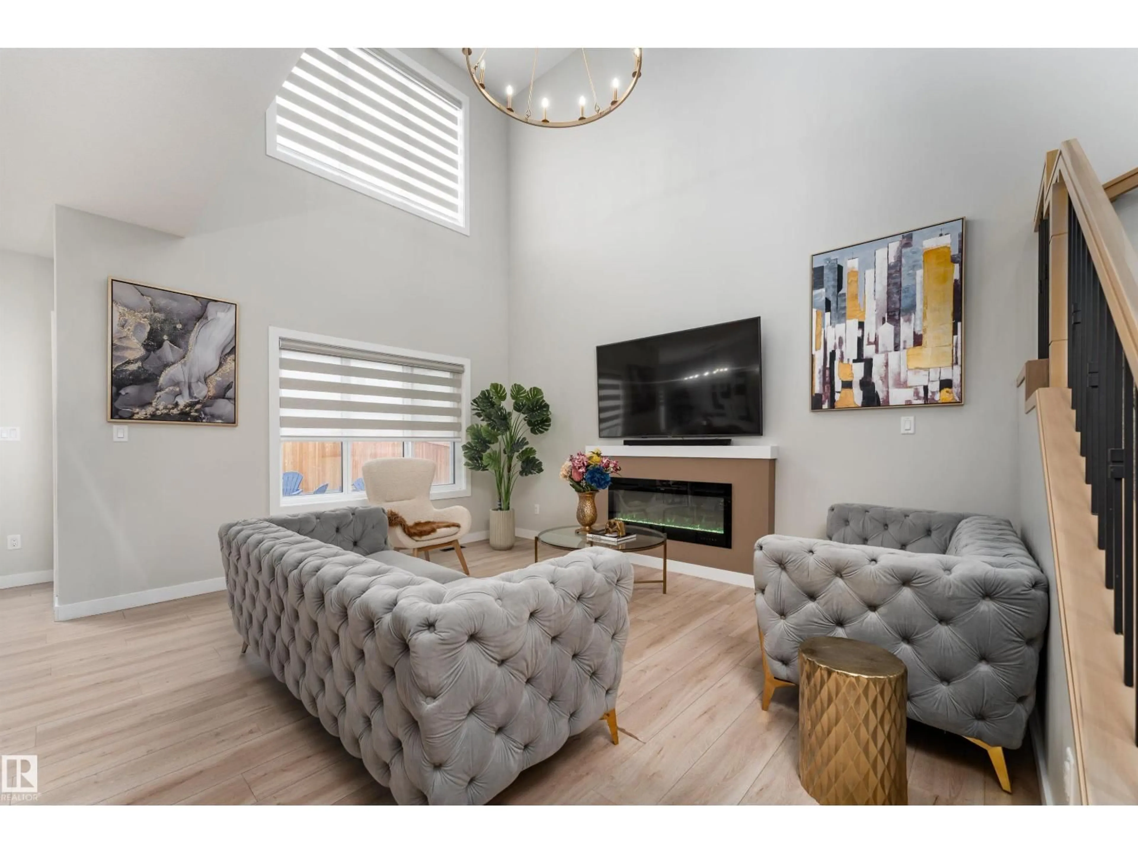 Living room with furniture, wood/laminate floor for 993 BERG PL, Leduc Alberta T9E1J7