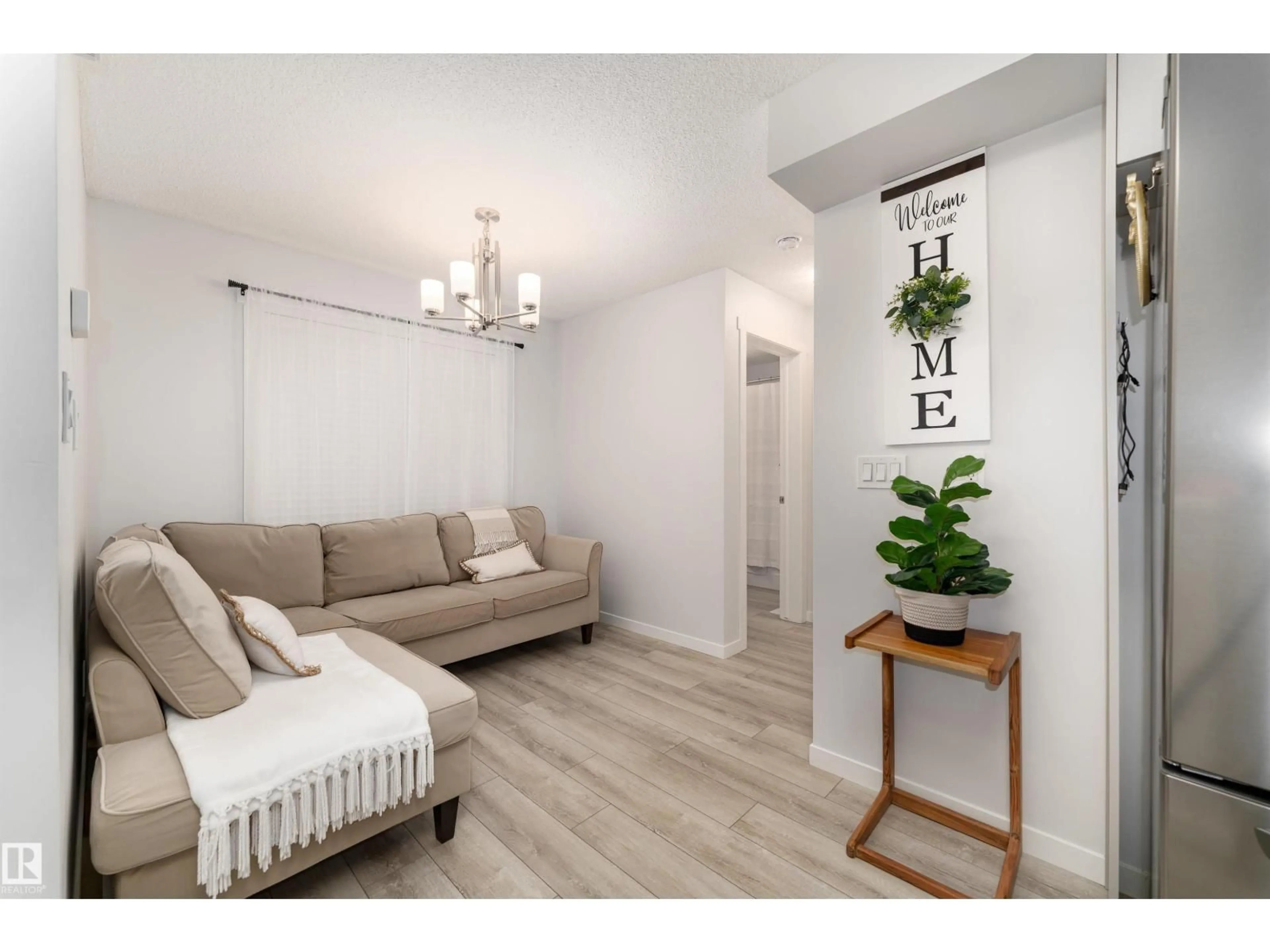 Living room with furniture, wood/laminate floor for #6 - 12815 CUMBERLAND RD, Edmonton Alberta T6V0M2