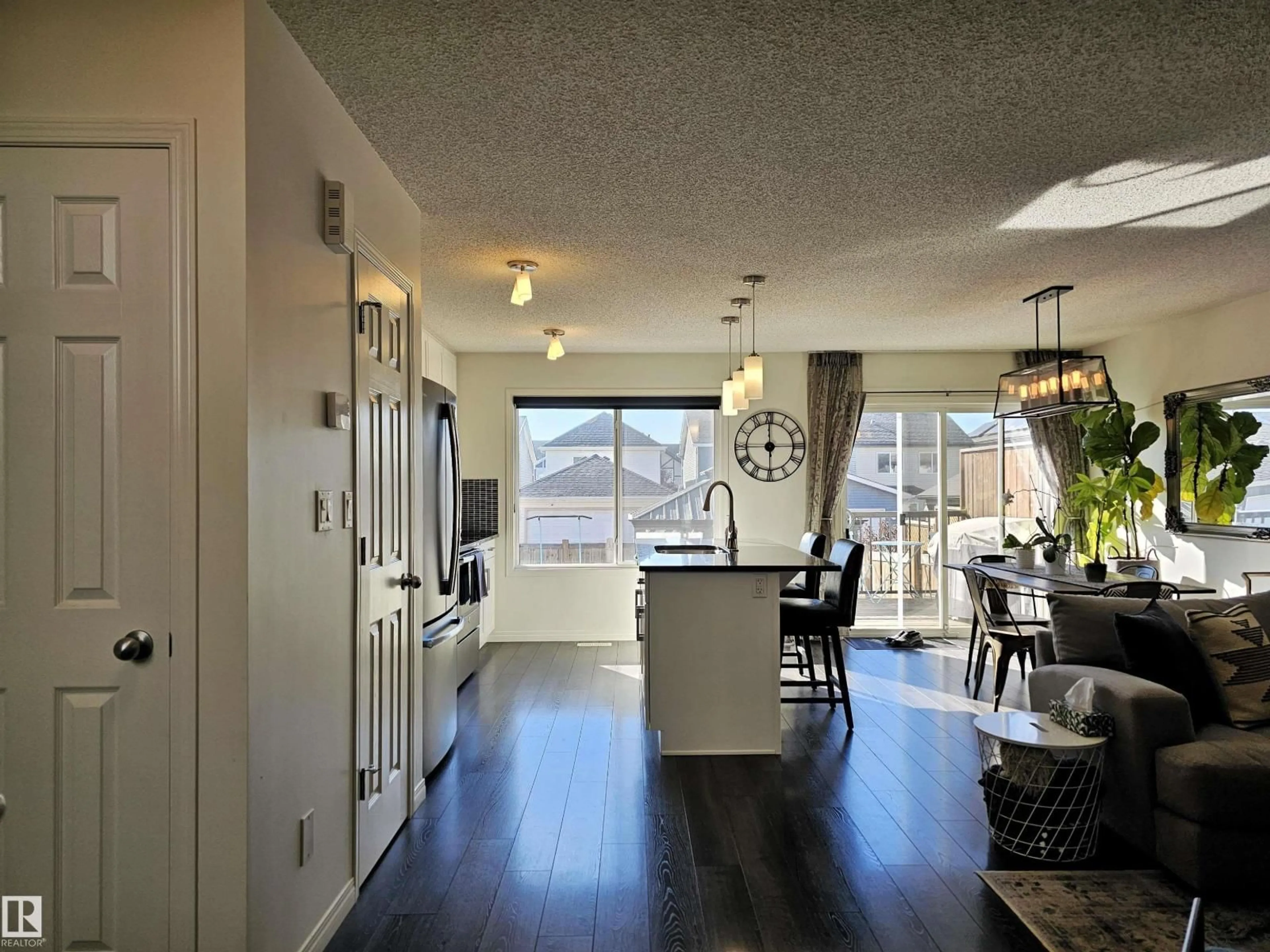 Open concept kitchen, wood/laminate floor for 6888 EVANS WD, Edmonton Alberta T6M0T8