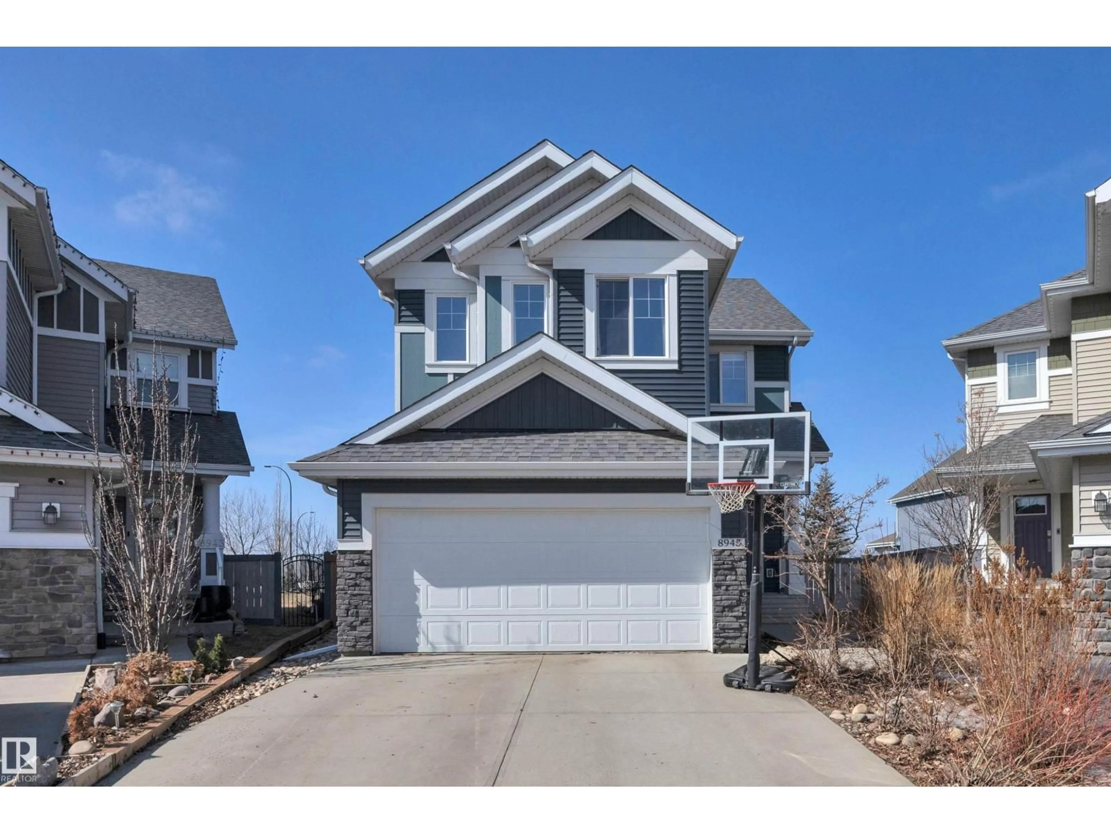 Home with vinyl exterior material, street for SW - 8945 24 AV, Edmonton Alberta T6X2C2