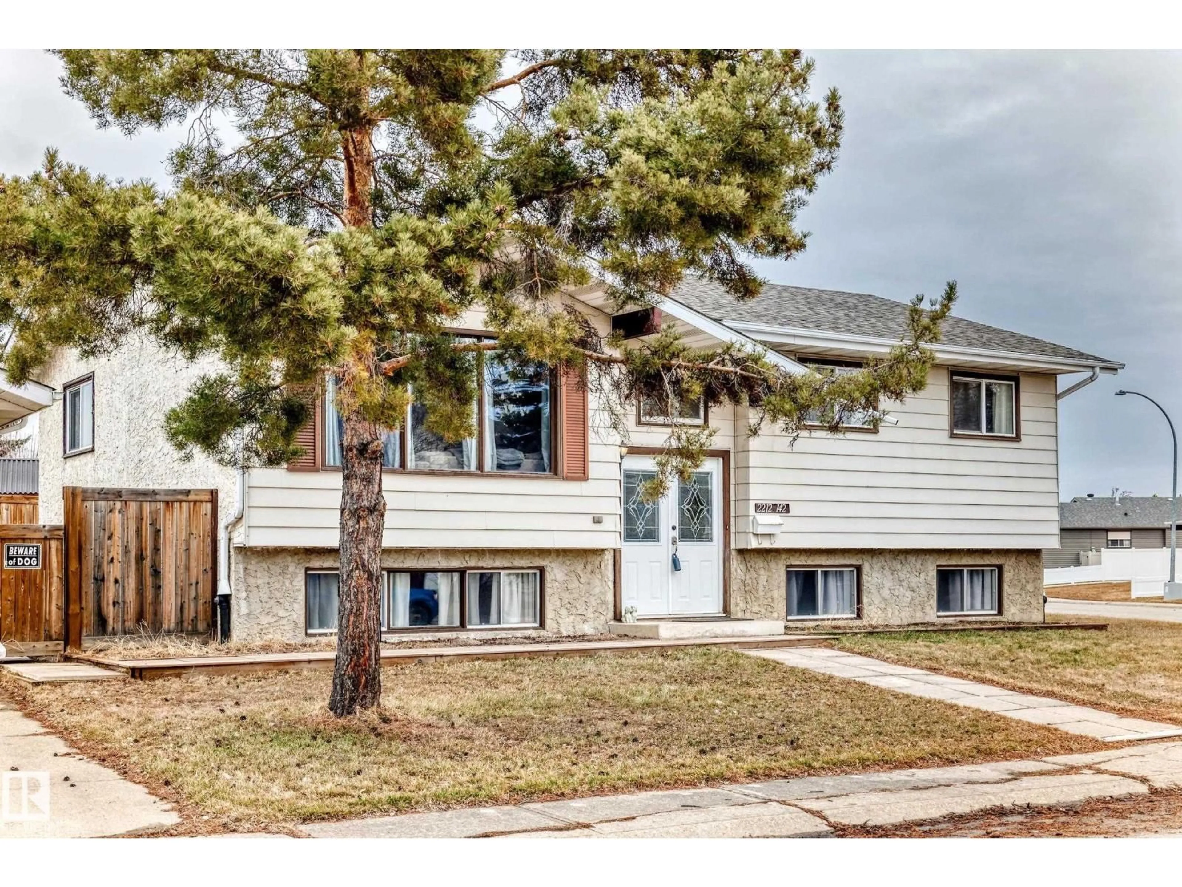 Home with vinyl exterior material, street for 2212 142 AV, Edmonton Alberta T5Y1E6